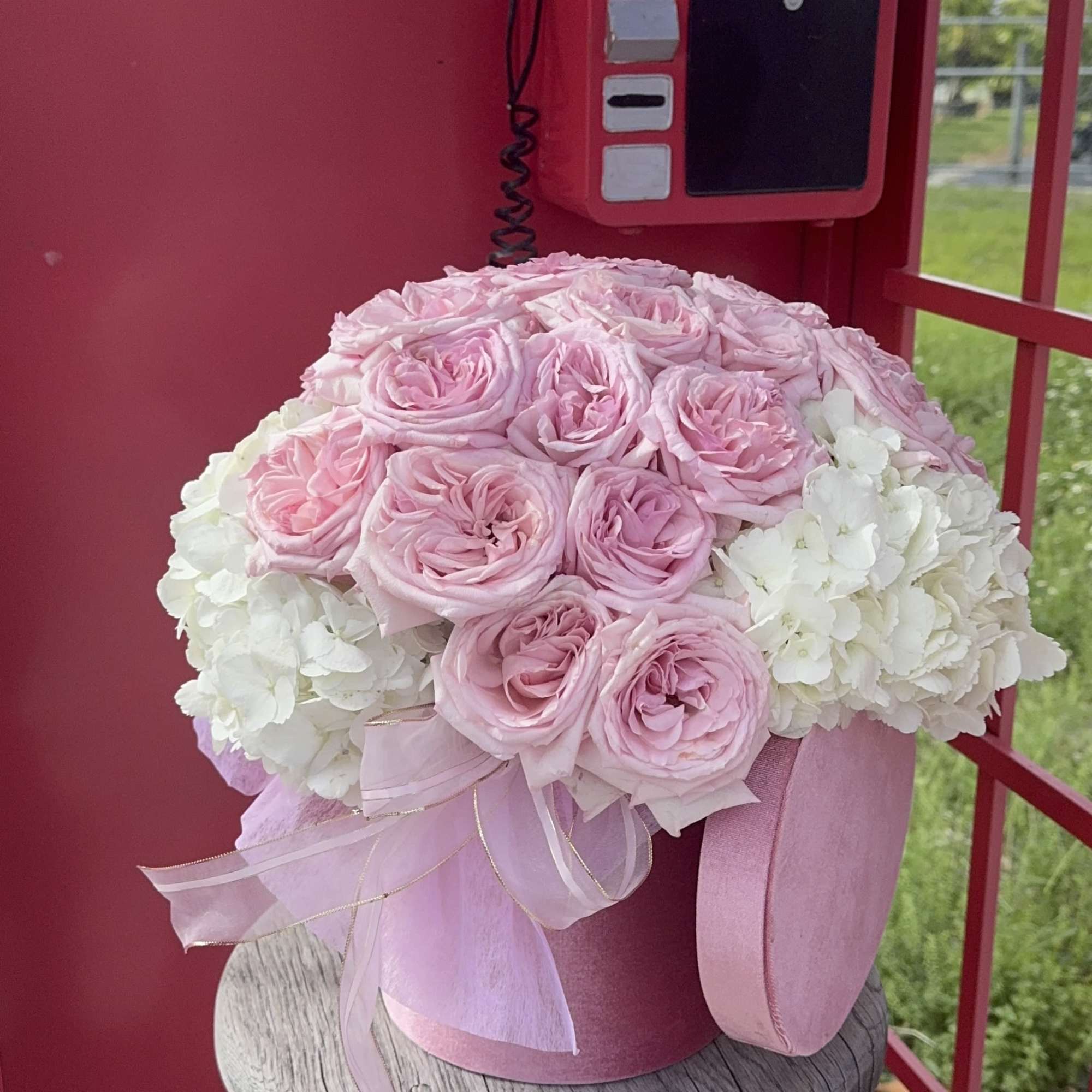 A box with hydrangeas and 12. roses