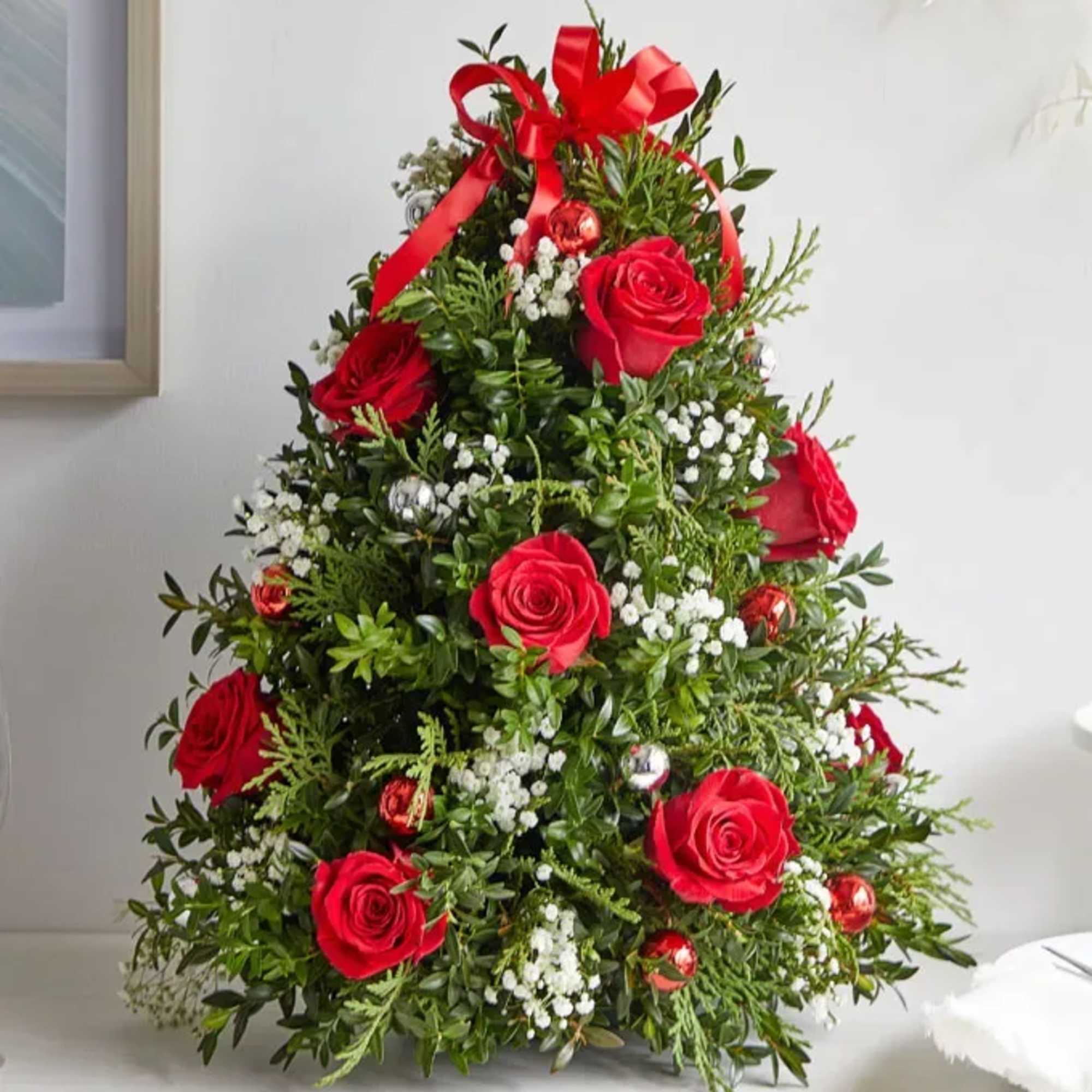 Celebrate the season with this festive floral arrangement designed in the shape