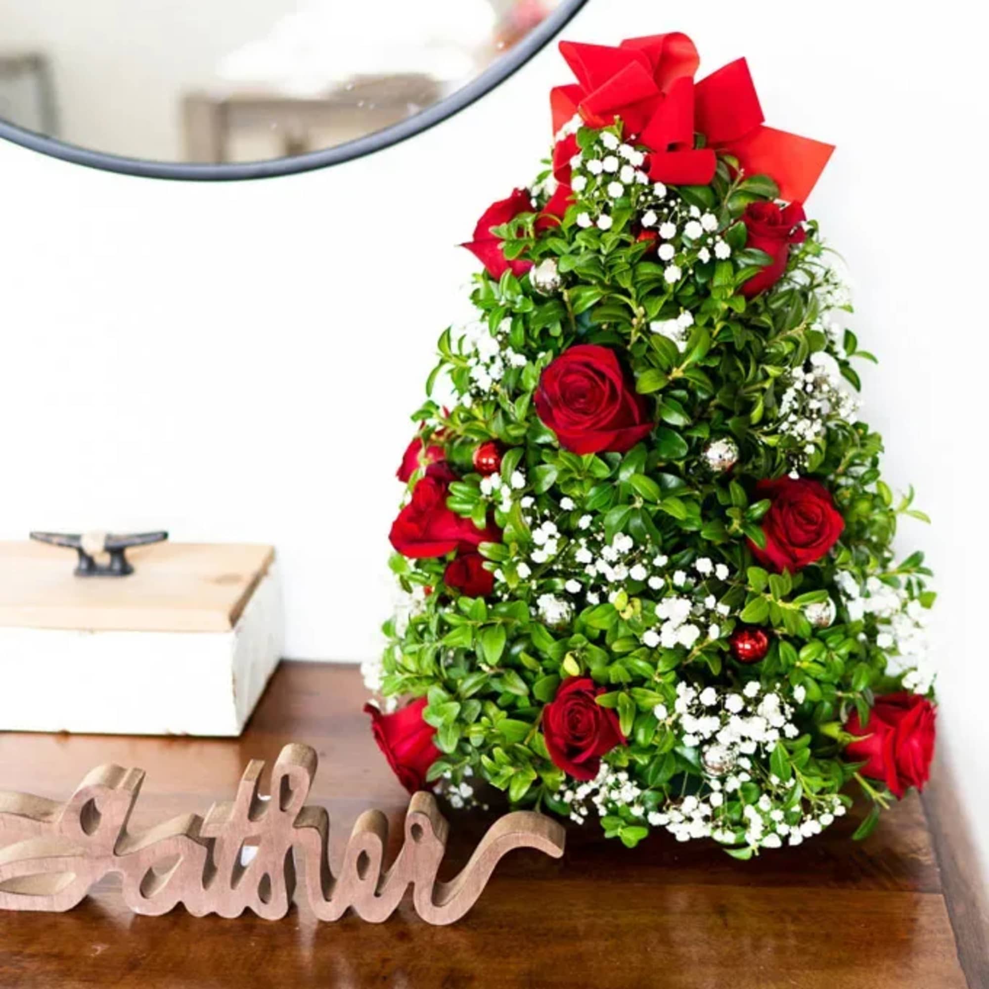 Celebrate the season with this festive floral arrangement designed in the shape