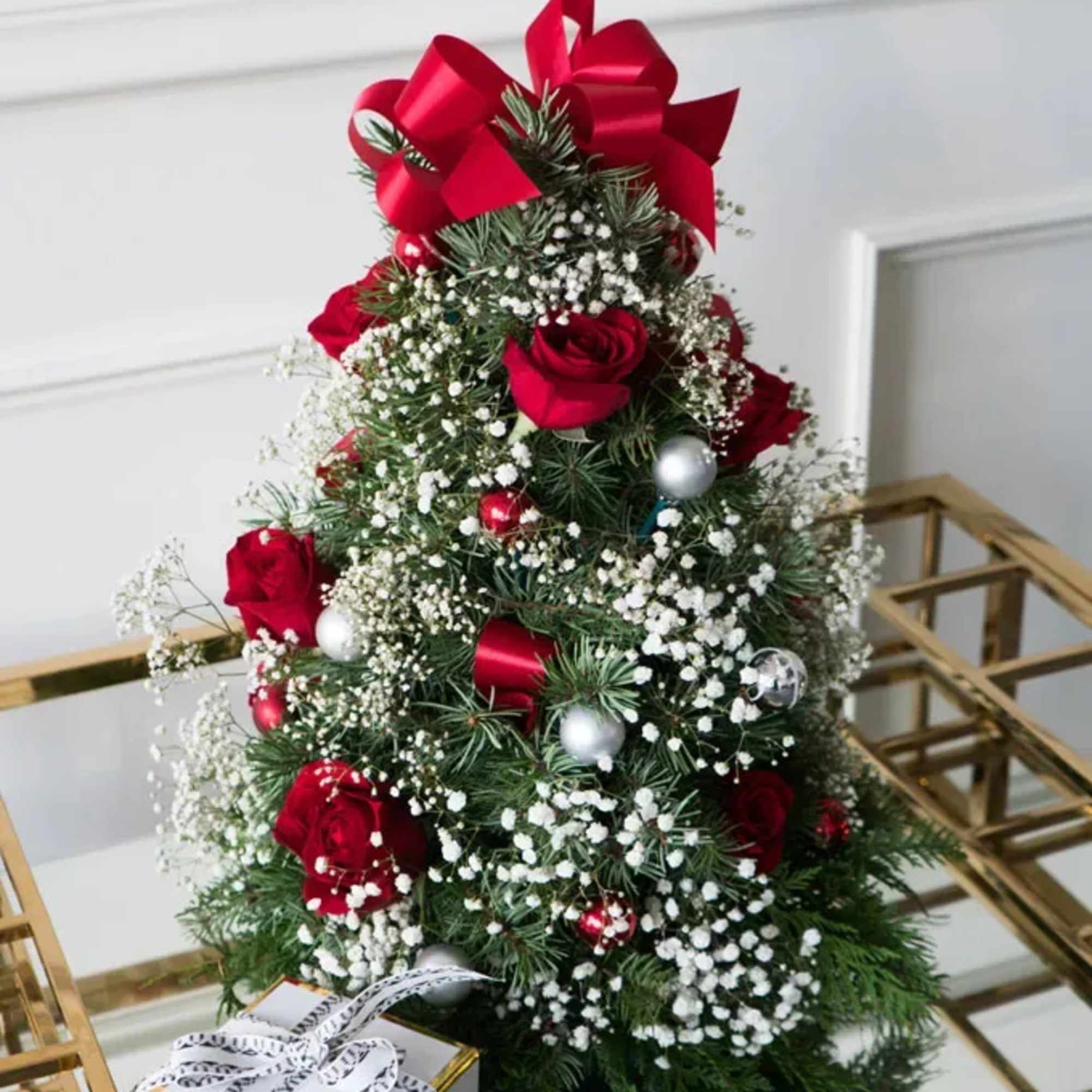 Celebrate the season with this festive floral arrangement designed in the shape