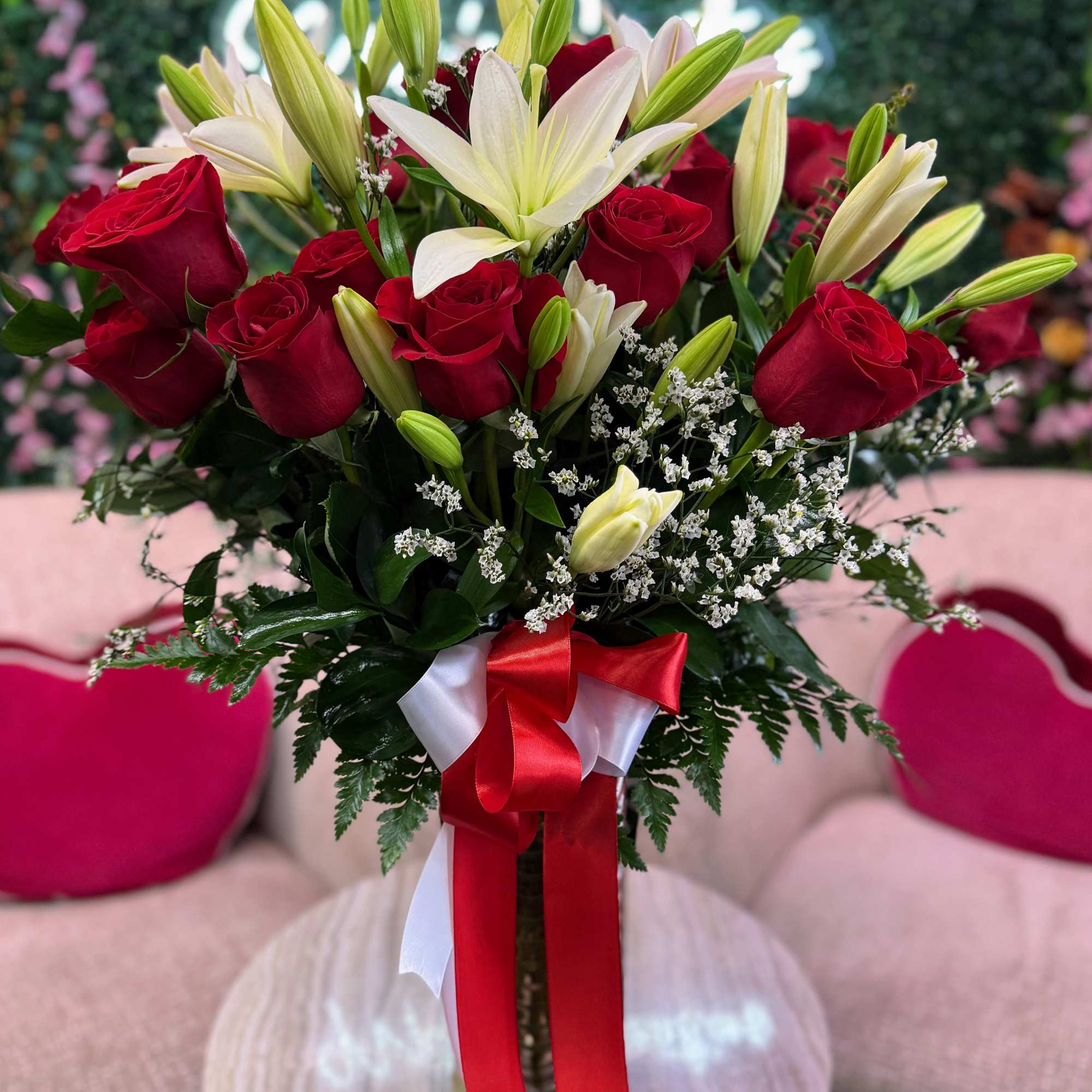 Beautiful fresh red roses paired with elegant white lilies, arranged in a