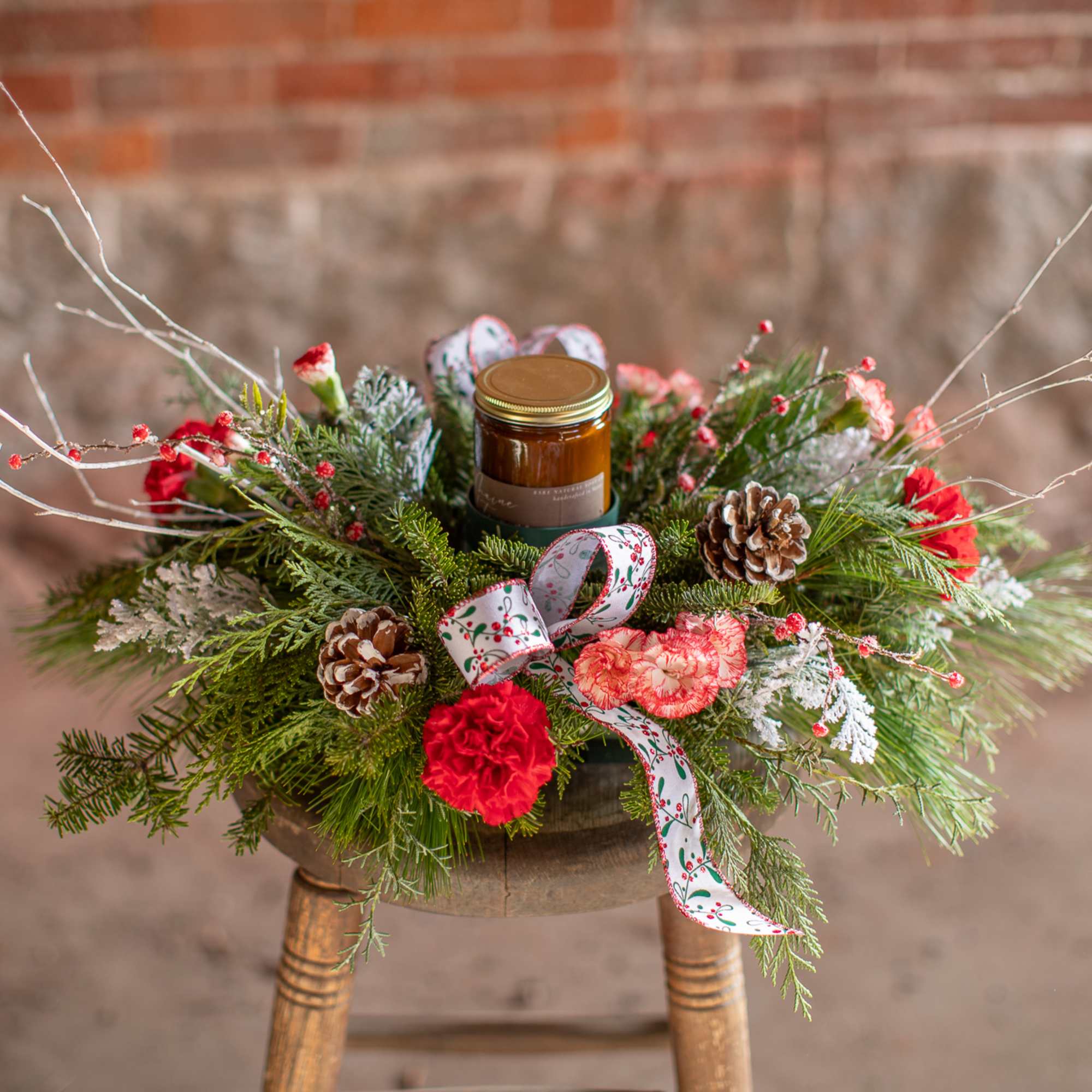 A lovely centerpiece of berries, branches, pinecones and favorite winter floral selections