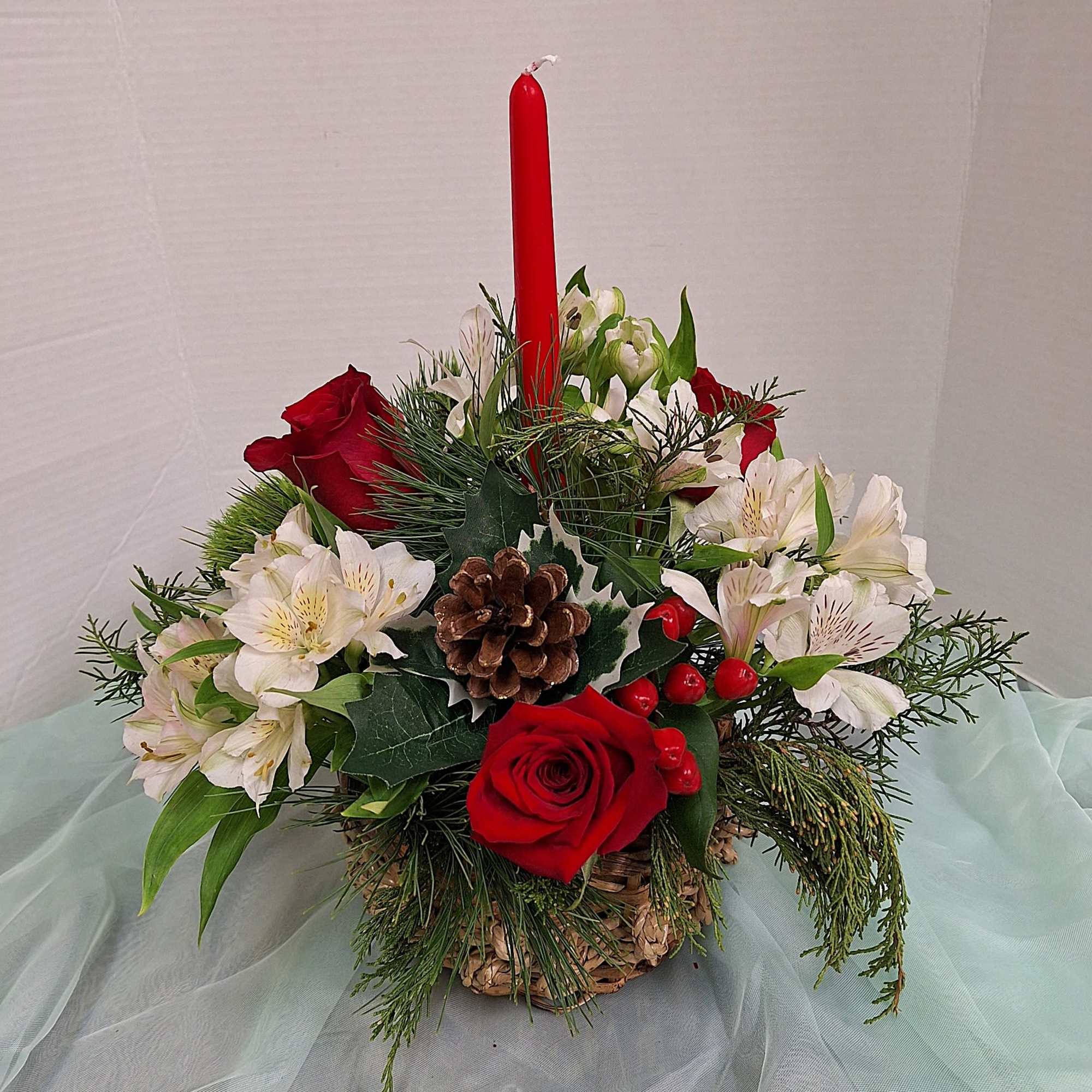 Assorted evergreen and cedar sprigs. Roses, alstromeria and berries
in a contemporary natural