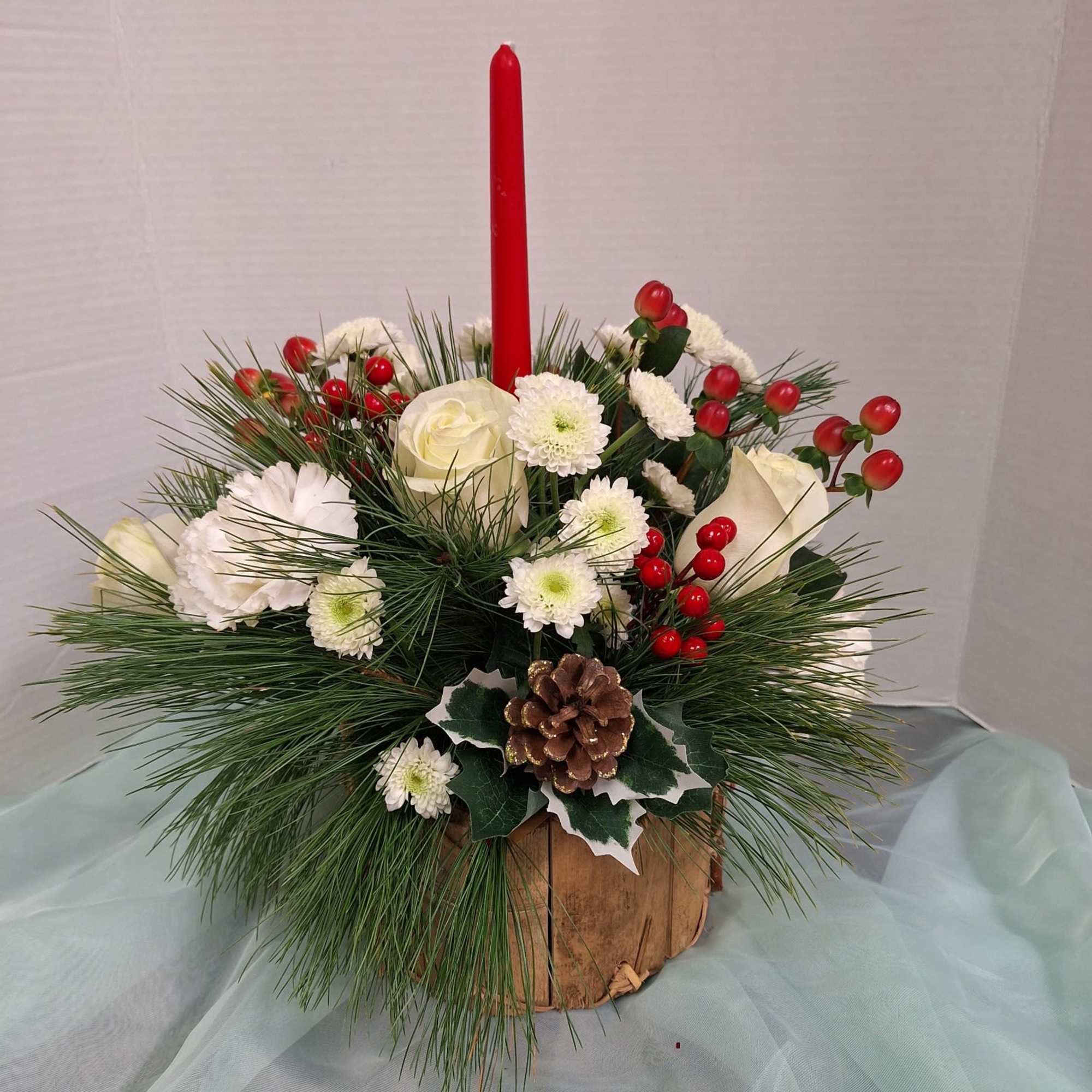 Crispy white carnations and roses nestled in this 
natural wood slat basket.