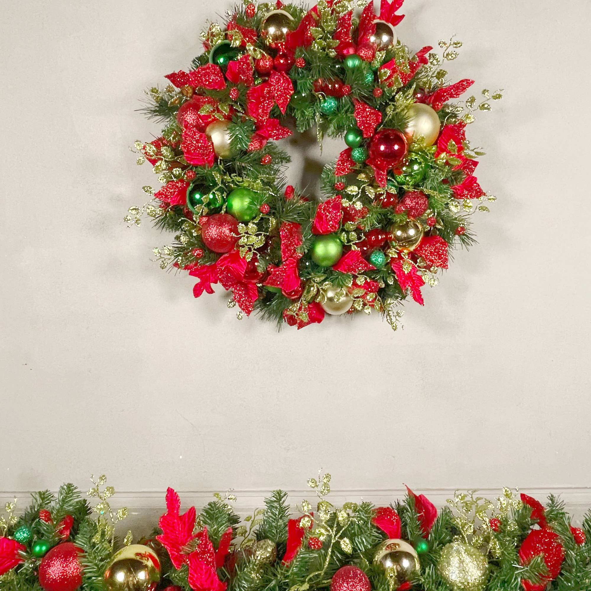 A traditional holiday wreath with beautiful red and green ornaments and a