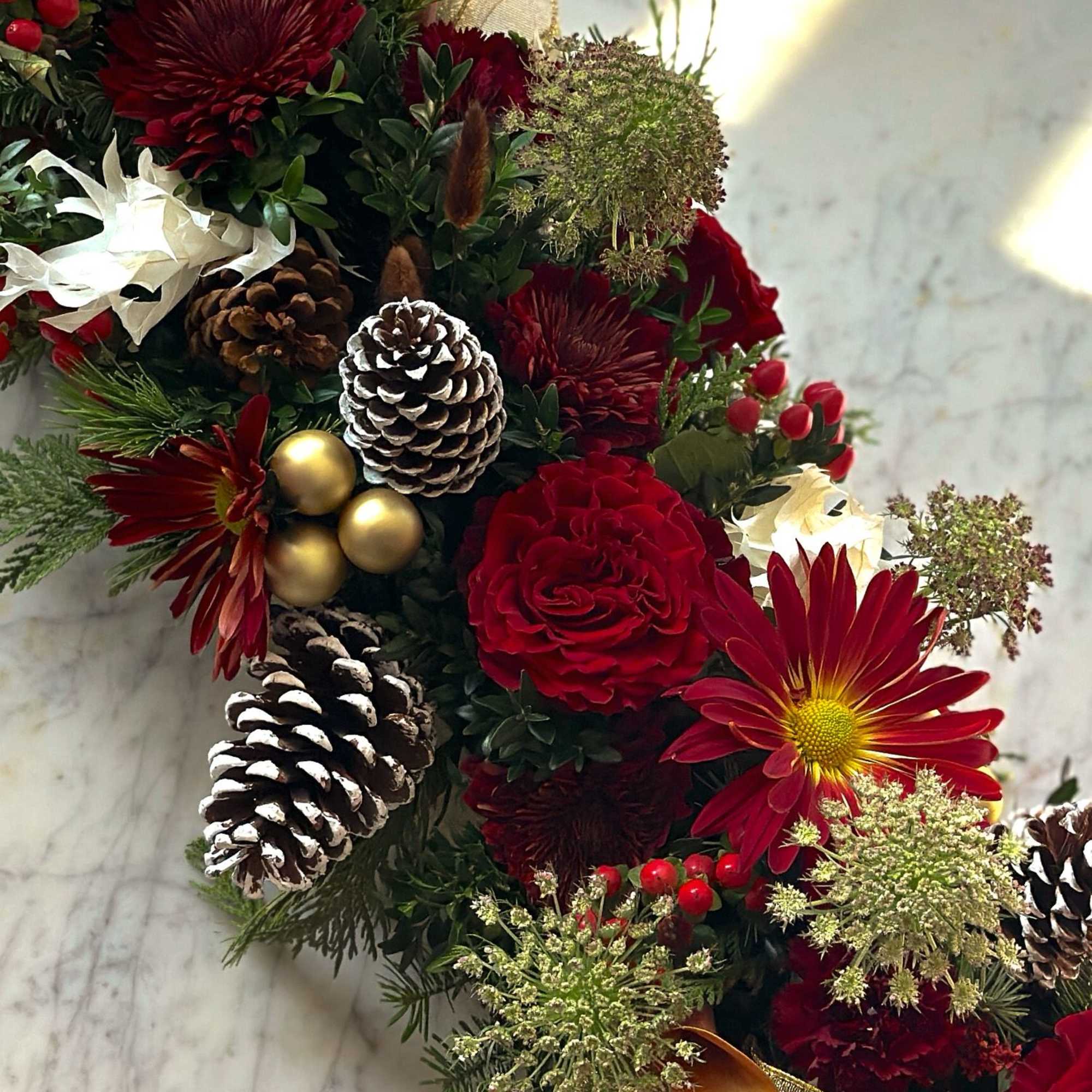 A mix of neutral reds, pinecones and fresh winter greens 

approx 18&quot;