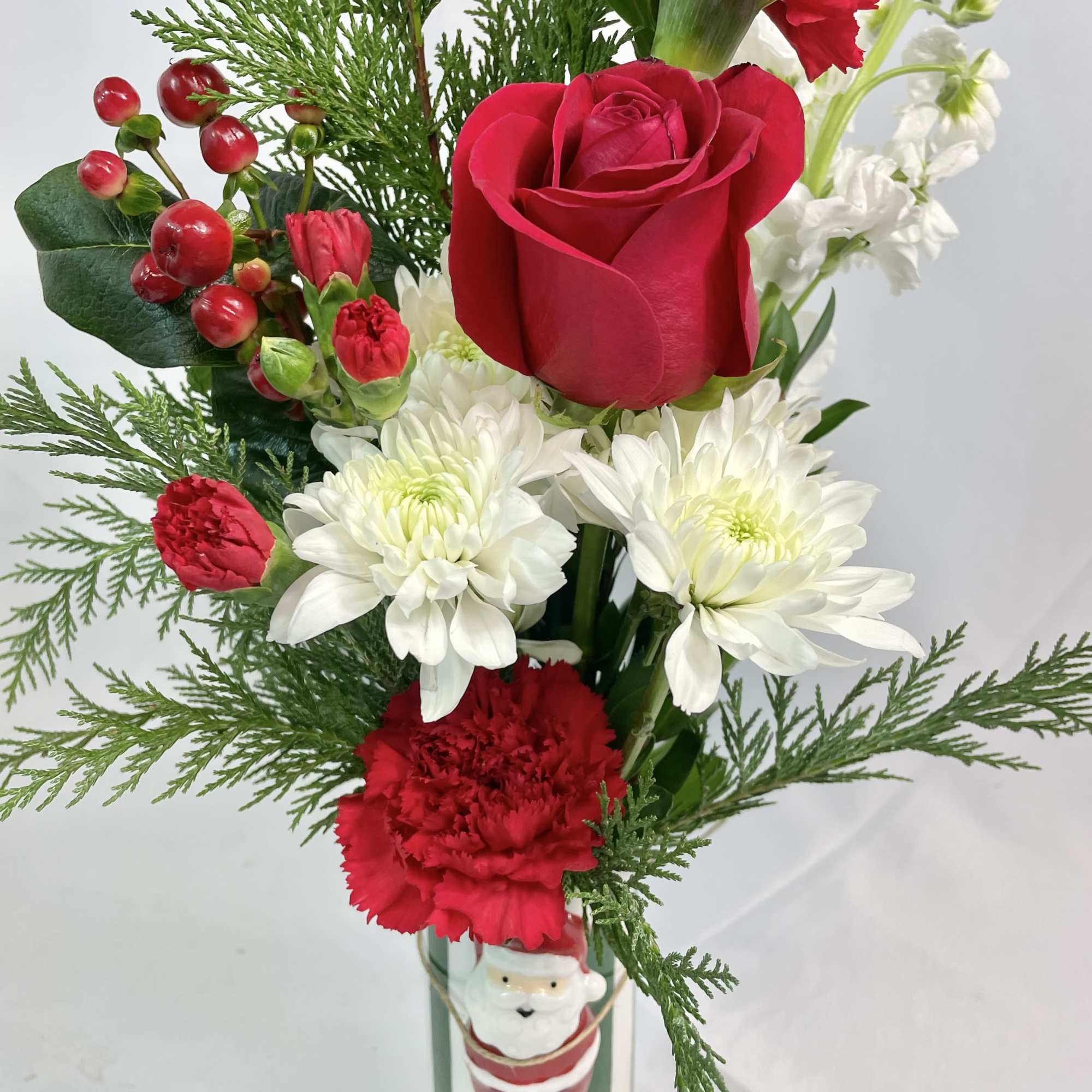 A holly jolly bouquet with a keepsake, ceramic, striped vase with Santa!