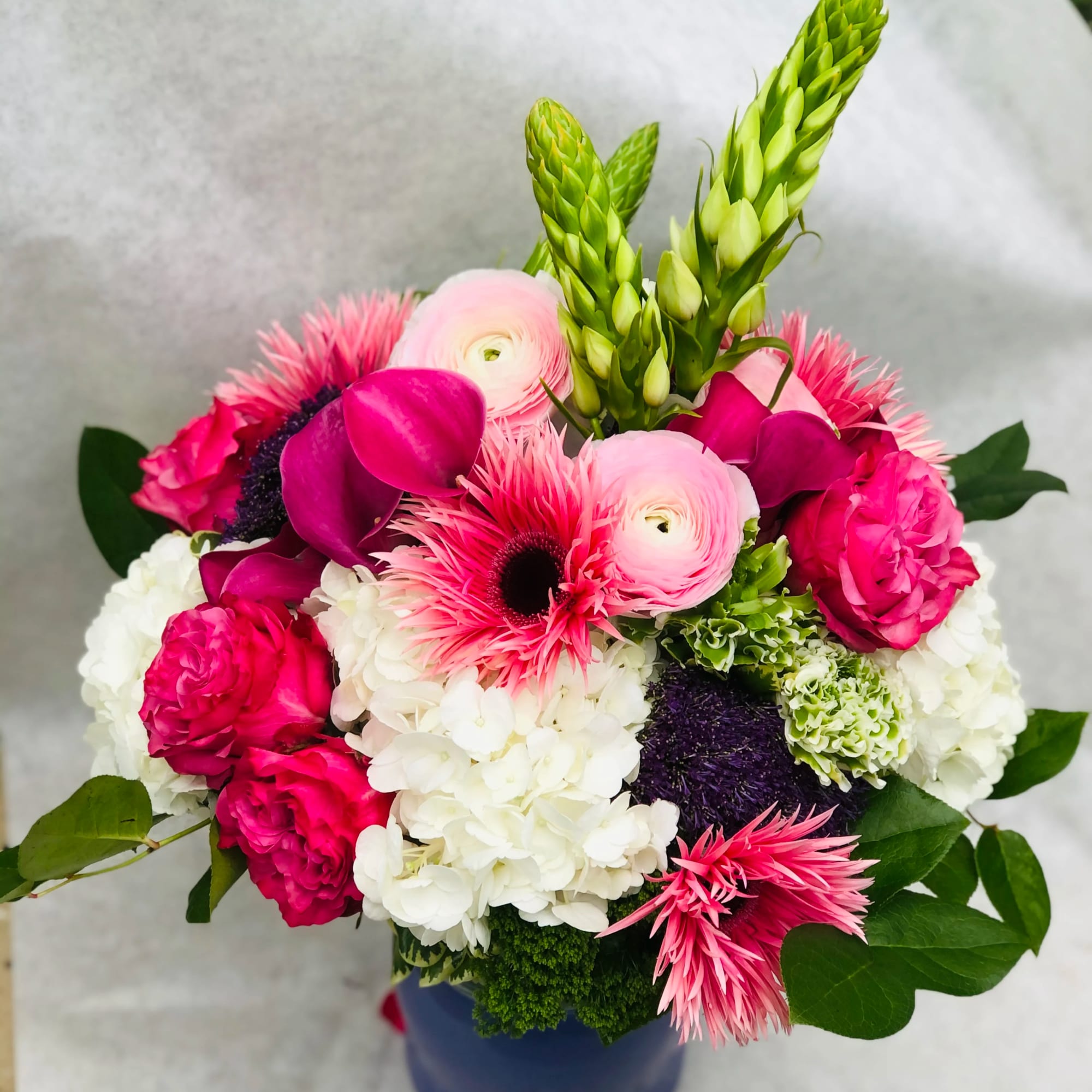 This stunning color display of Hydragea, Gerbera Daisies, Roses, calls lullies and