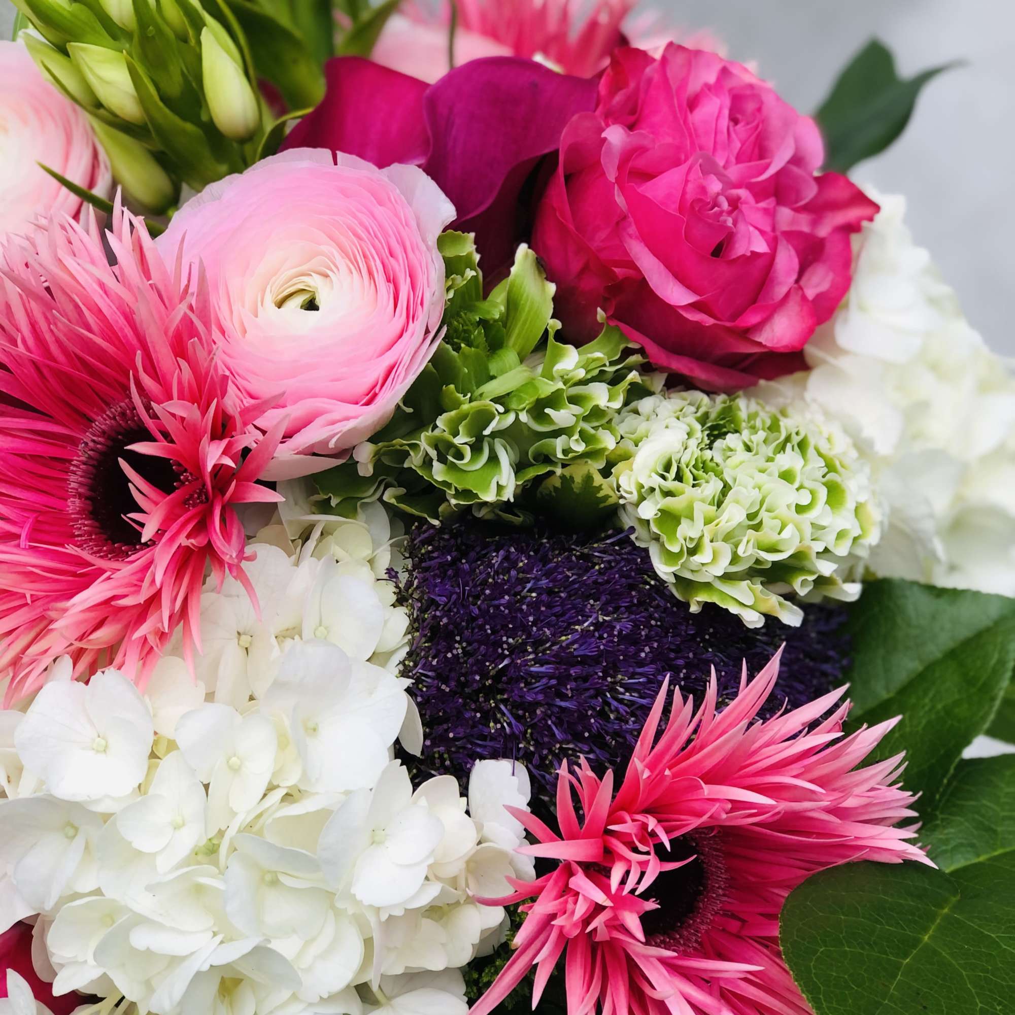 This stunning color display of Hydragea, Gerbera Daisies, Roses, calls lullies and