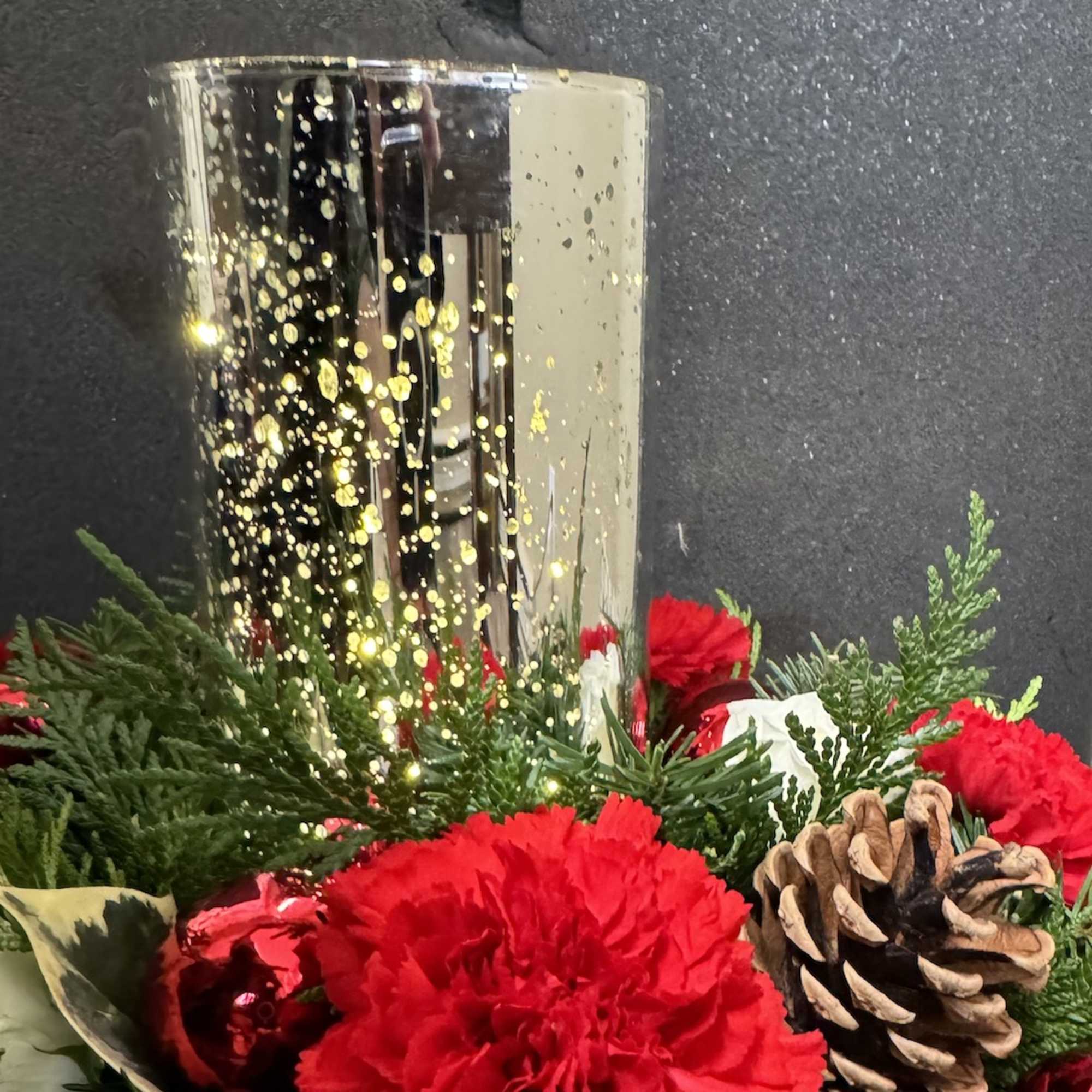 This is a Christmas centerpiece with hurricane that includes fairy lights that