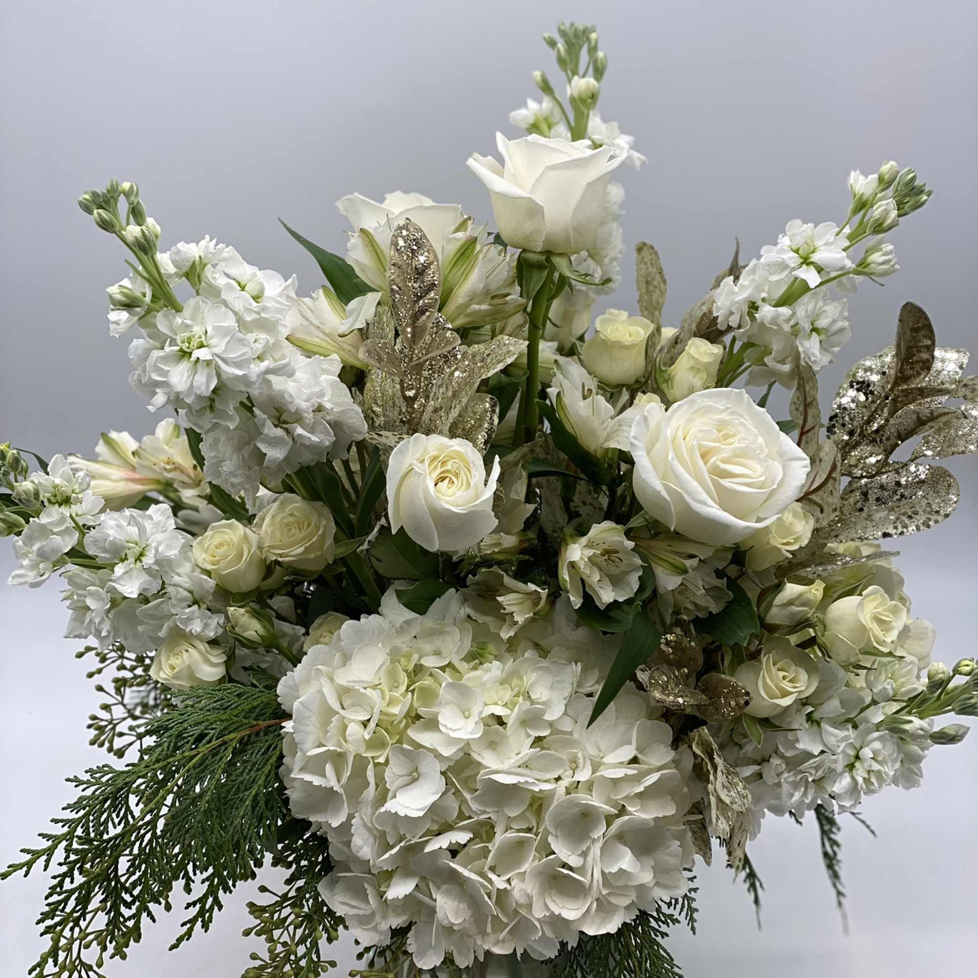 This grande arrangement has the sentiment of the season, embraced in a
