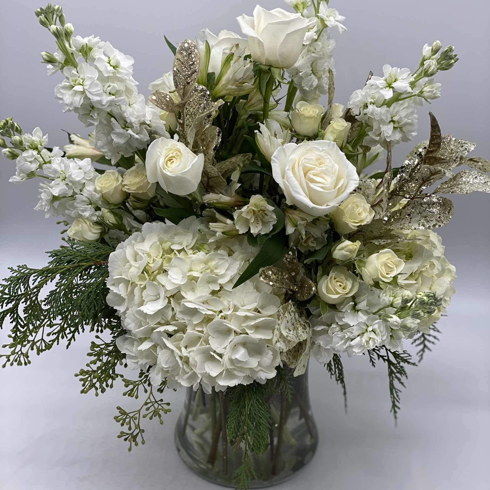 This grande arrangement has the sentiment of the season, embraced in a