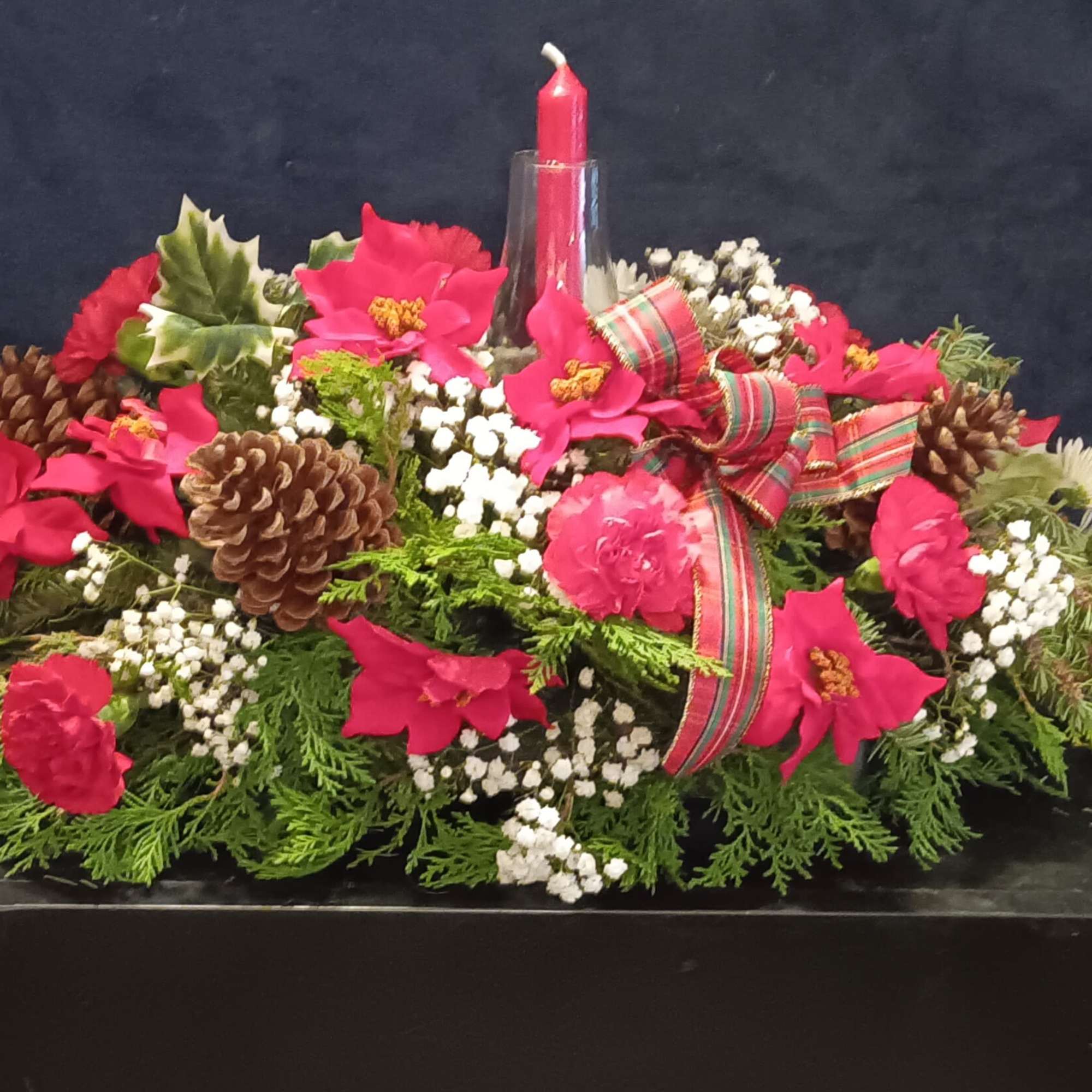 Mixed floral Arrangement with candle accented by fragrant greens and and pine