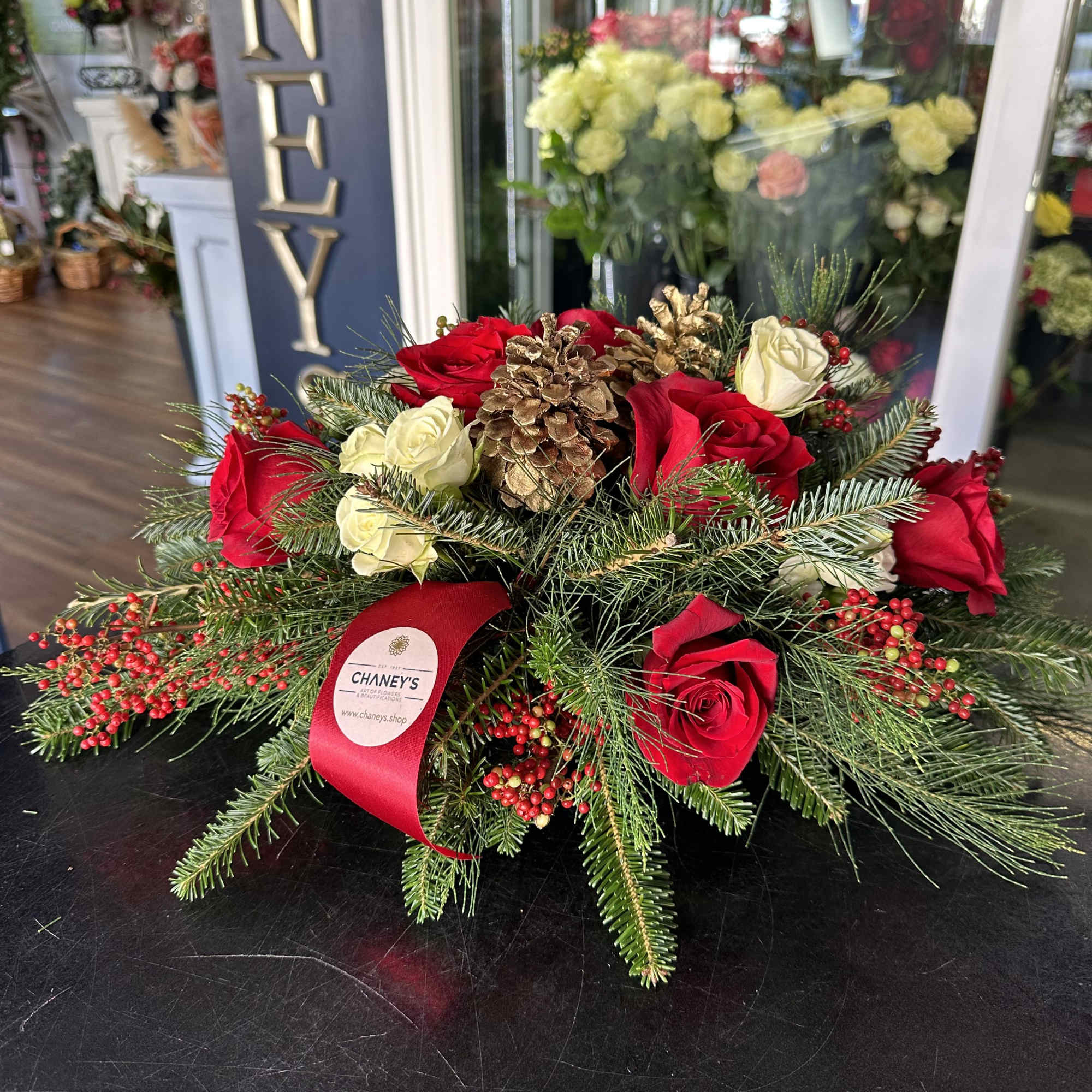 Centerpiece red and white with seasonal decoration and fresh Christmas greens