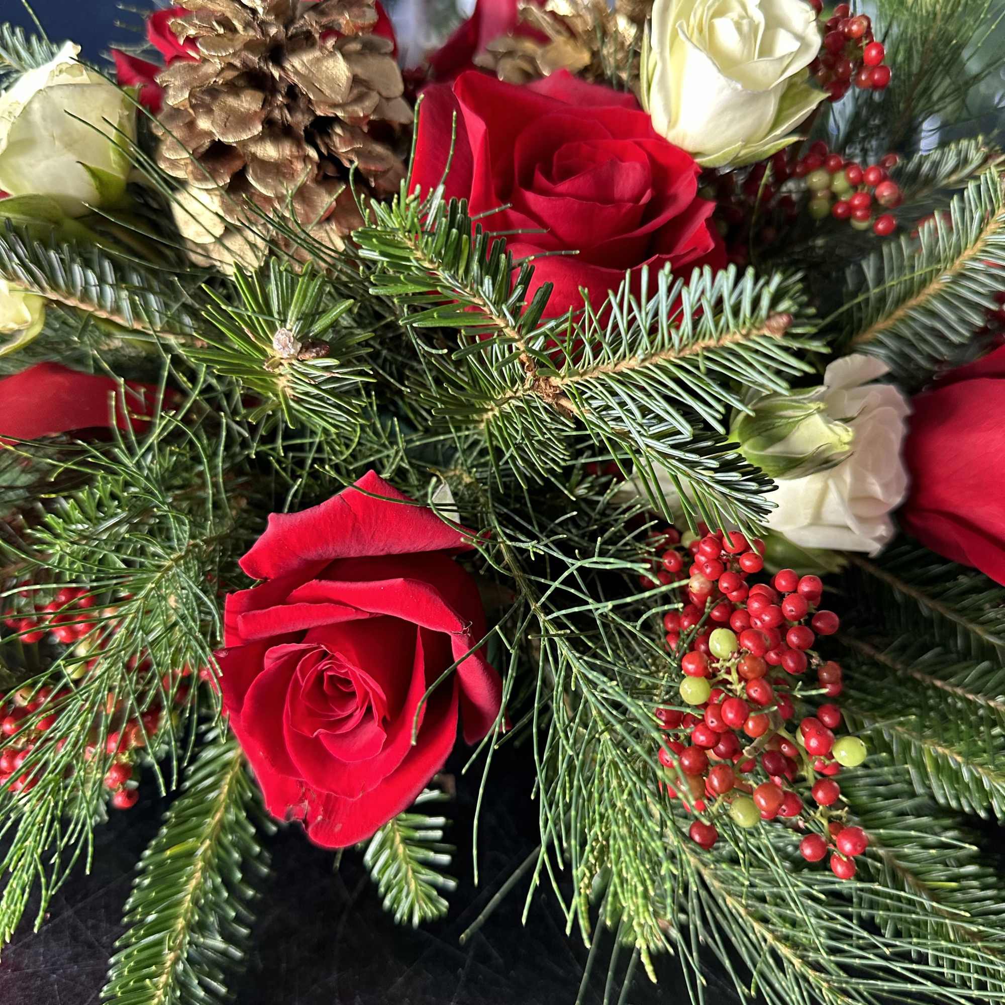 Centerpiece red and white with seasonal decoration and fresh Christmas greens