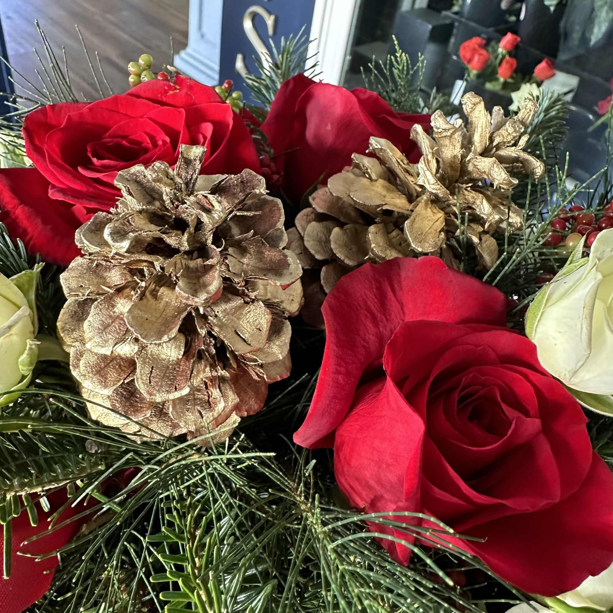 Centerpiece red and white with seasonal decoration and fresh Christmas greens