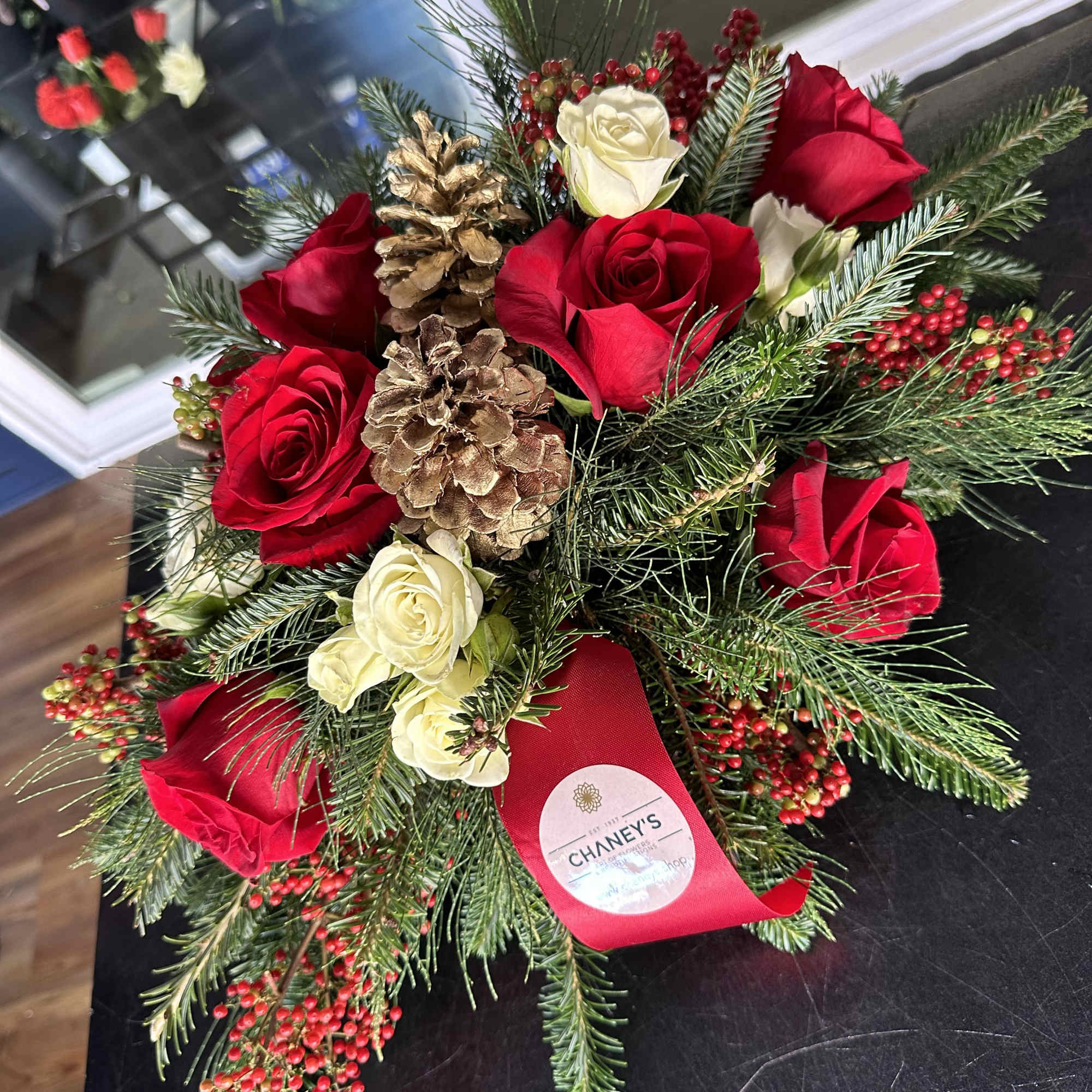 Centerpiece red and white with seasonal decoration and fresh Christmas greens