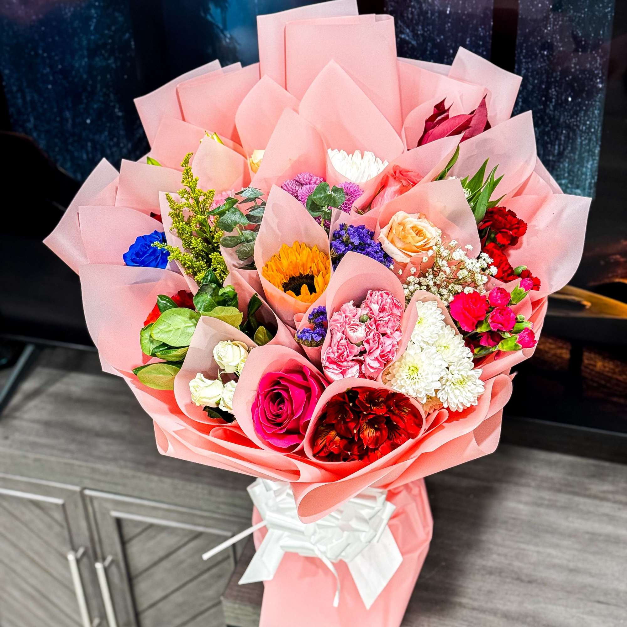 is a stunning hand-crafted bouquet wrapped in our signature Korean-style blush wrap.