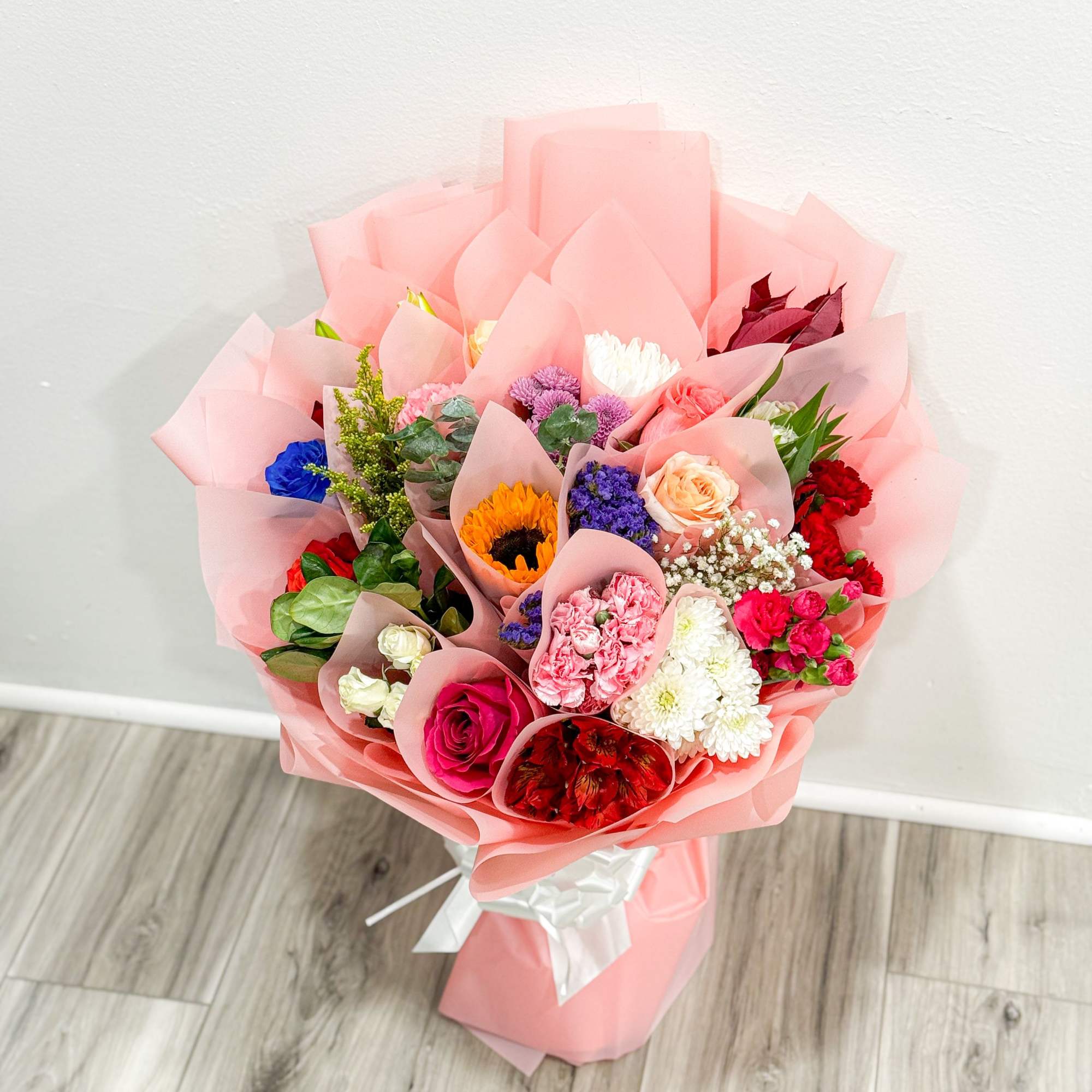 is a stunning hand-crafted bouquet wrapped in our signature Korean-style blush wrap.