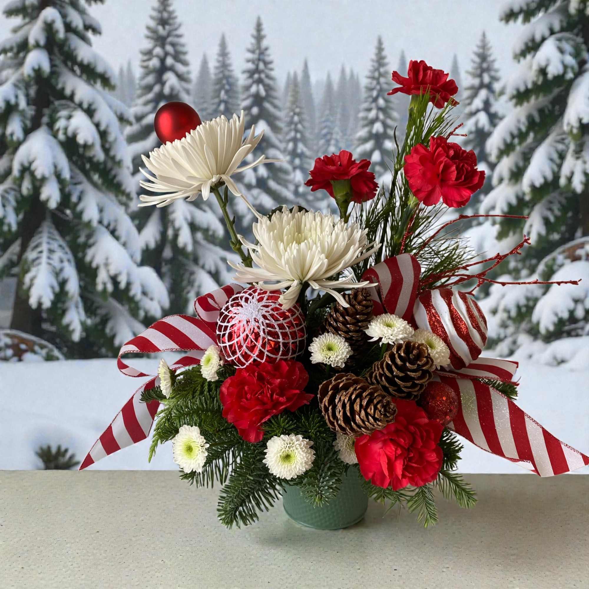 Send whimsical Christmas cheer with this arrangement bursting with charm, playful ribbons