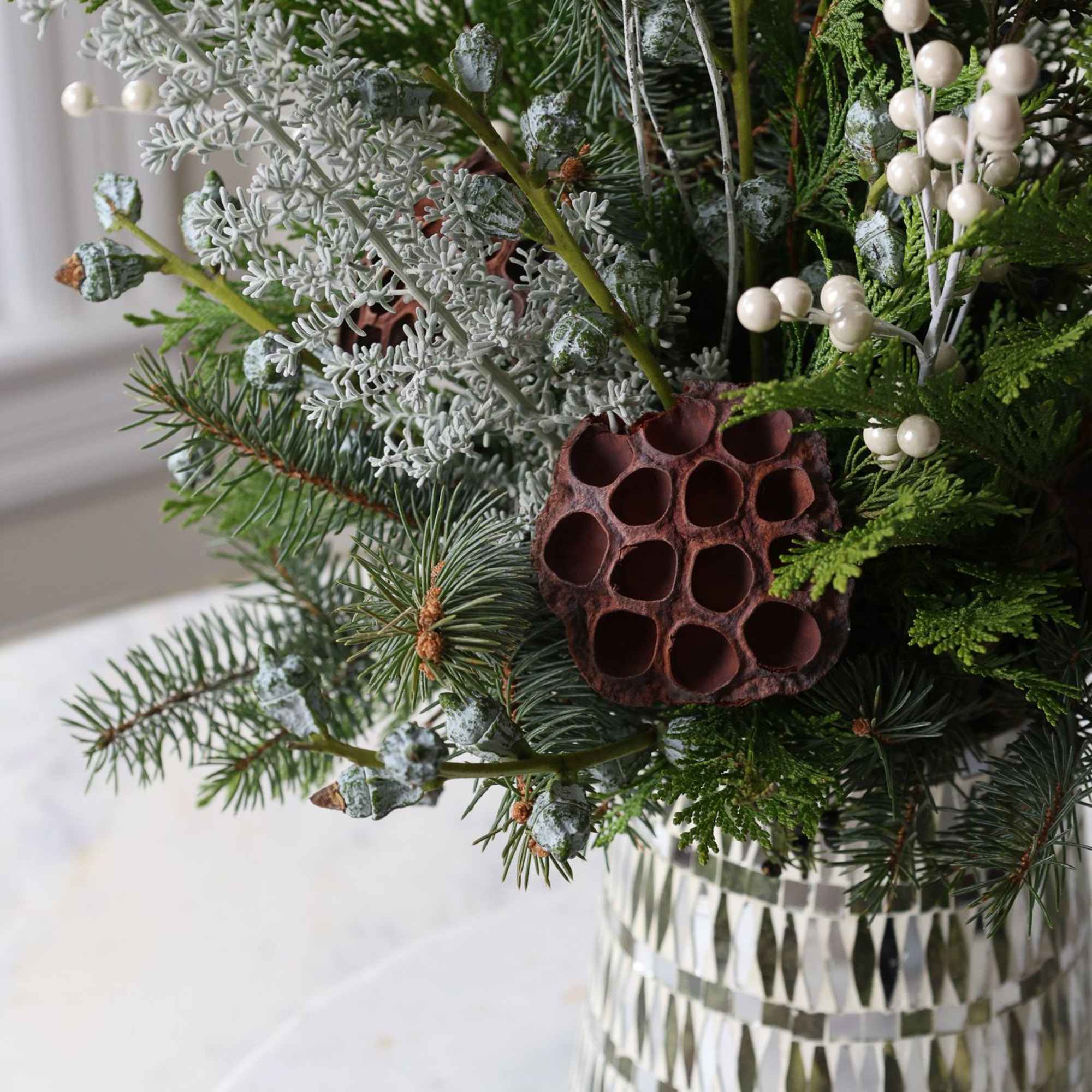 Winter greens and frosted foliage with some berry accents and lotus pods