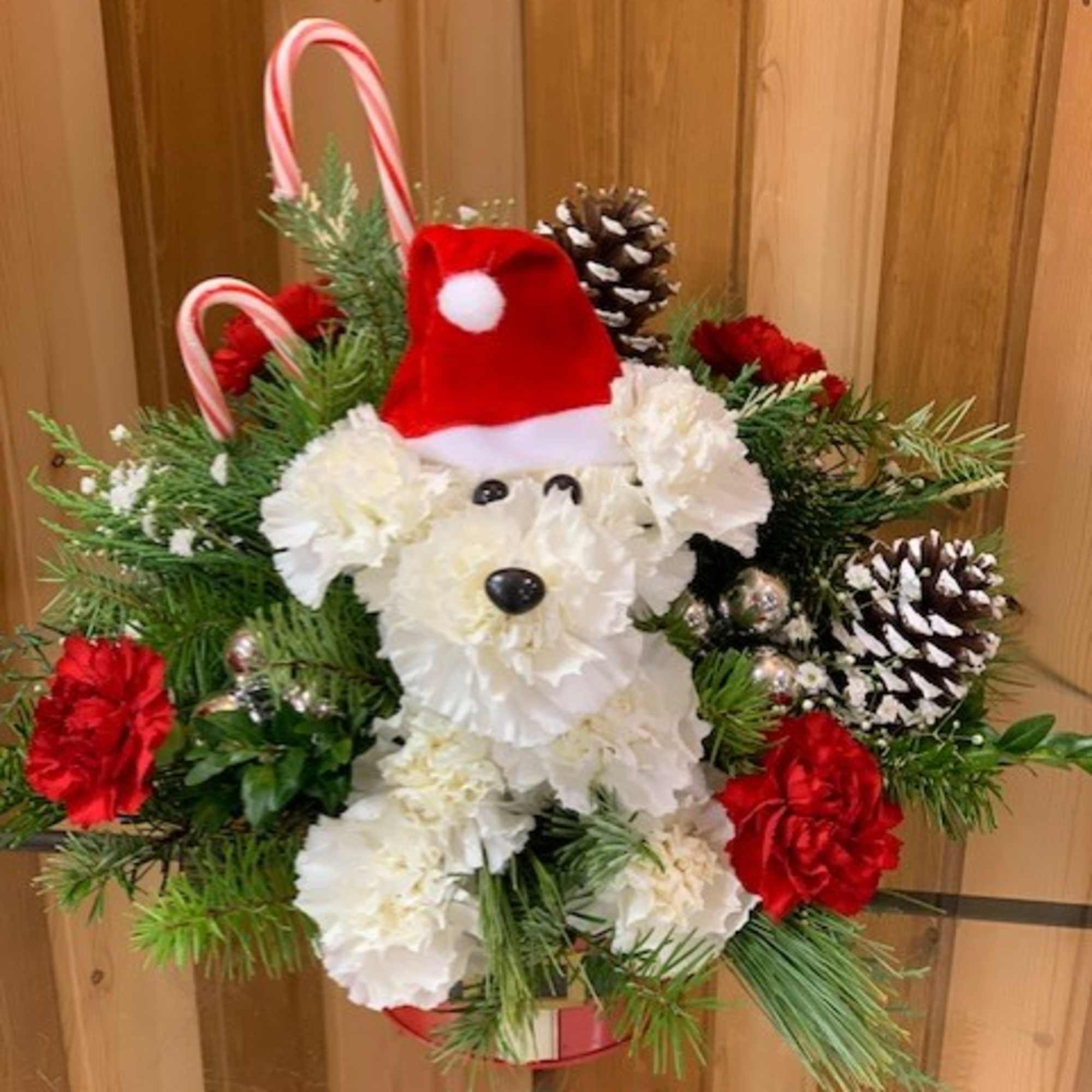 Christmas Puppy arrangement featuring a dog made out of carnations with a
