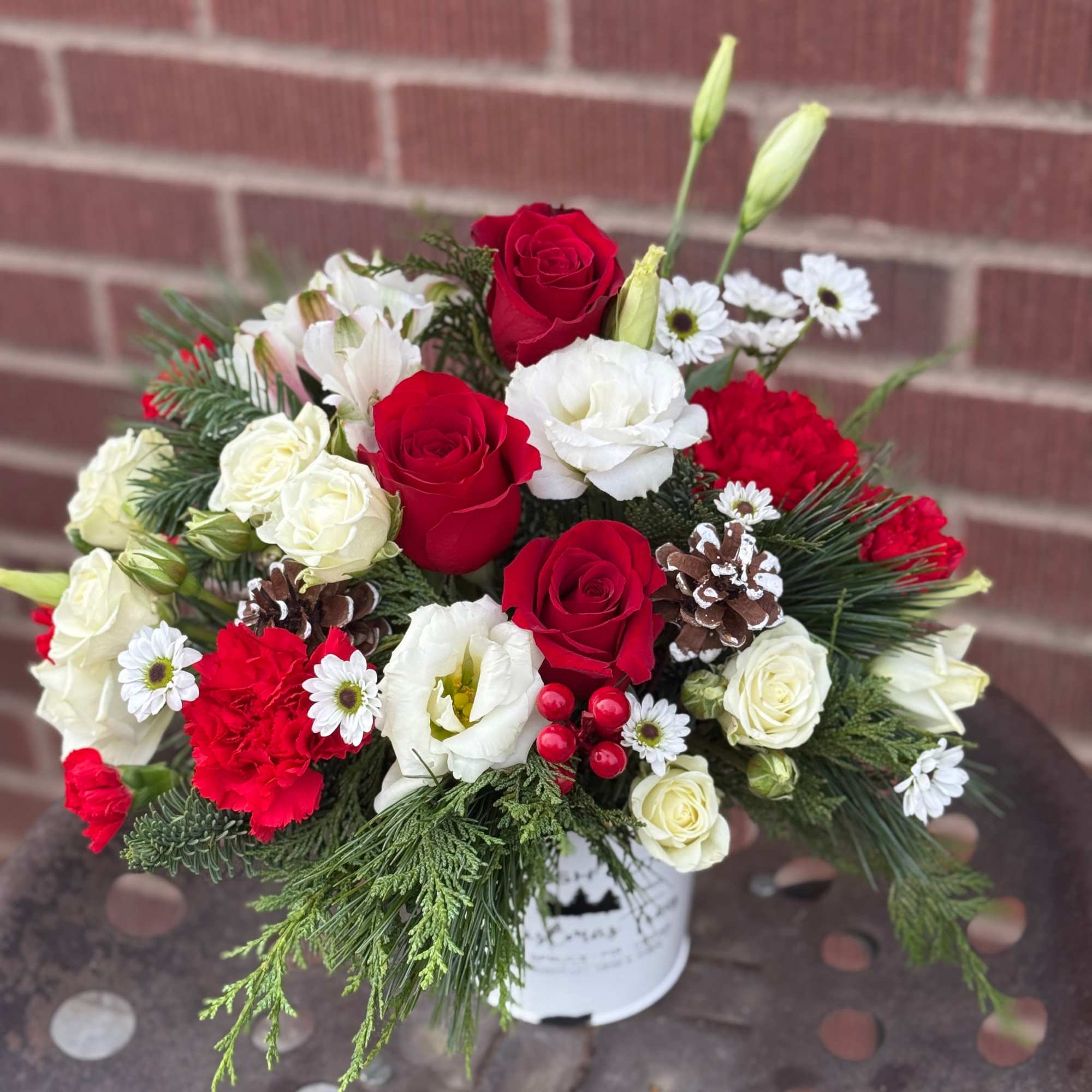 In a rustic, decorative tree farm tin and full of fresh pine.