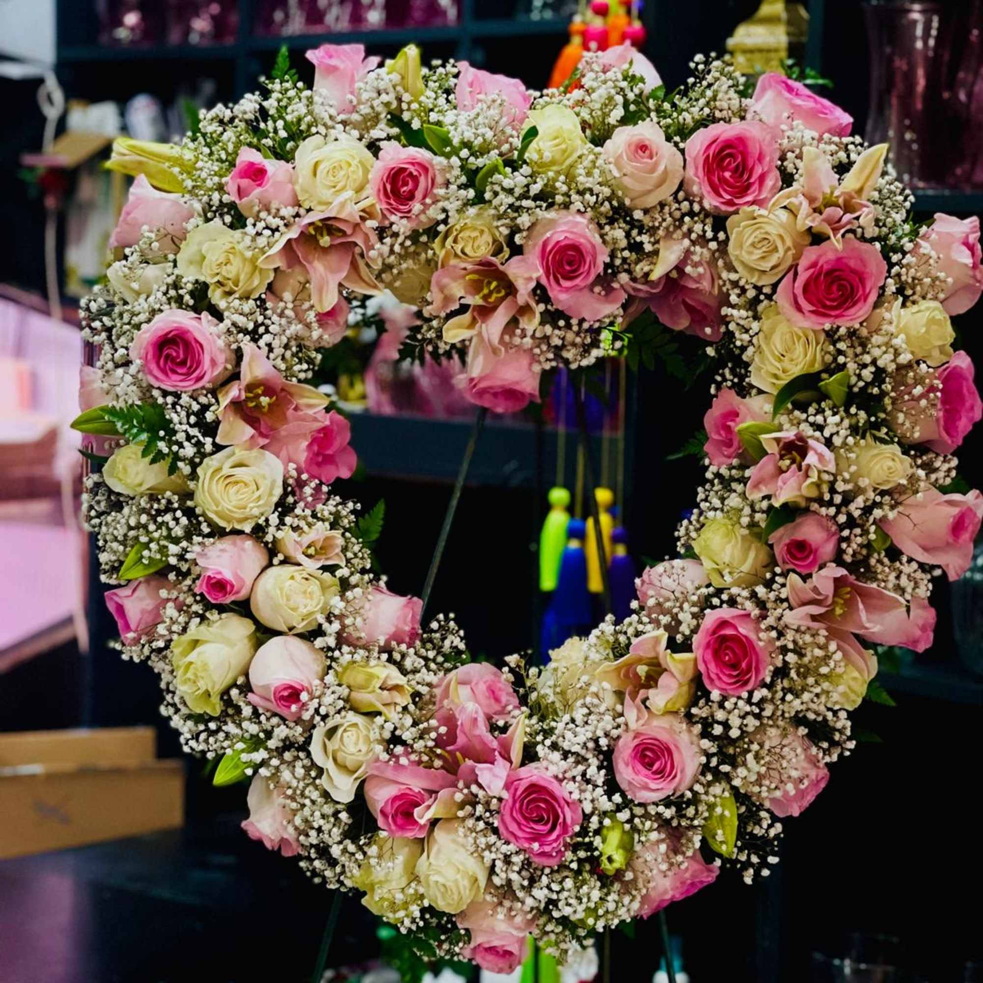 This stunning heart-shaped floral wreath is a symbol of love and remembrance.