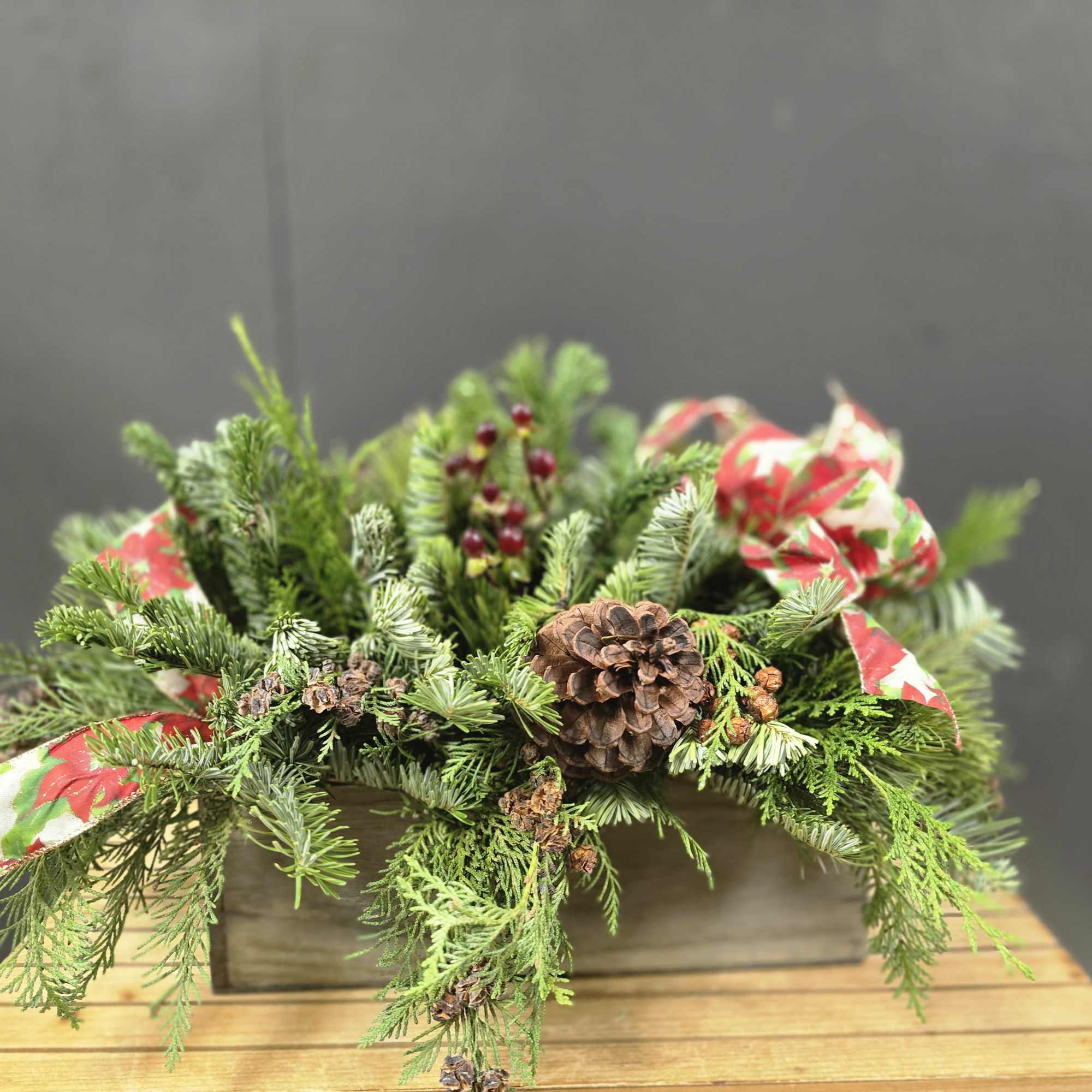 This arrangement is designed all around with a mix of evergreen and