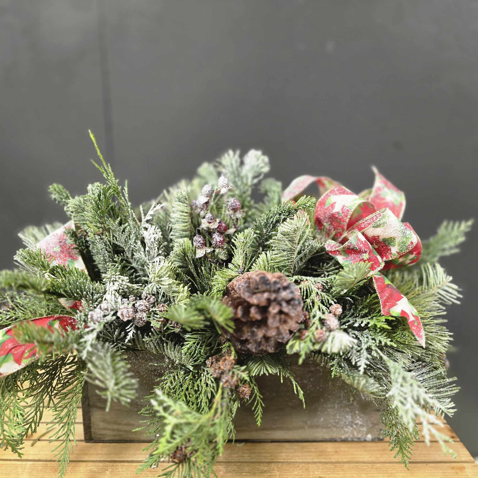 This arrangement is designed all around with a mix of evergreen and