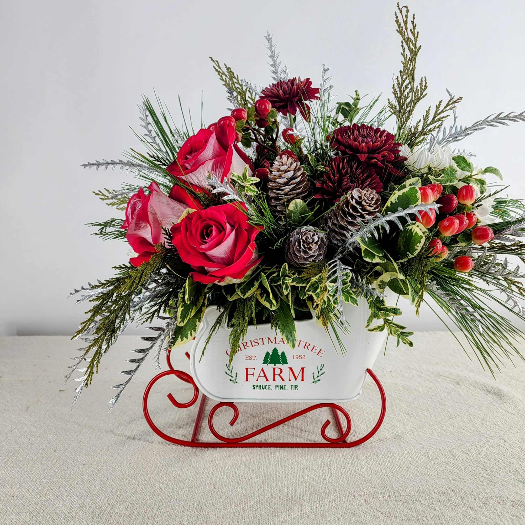 This festive sleigh embodies our Winter wonderland. It is adorned with roses
