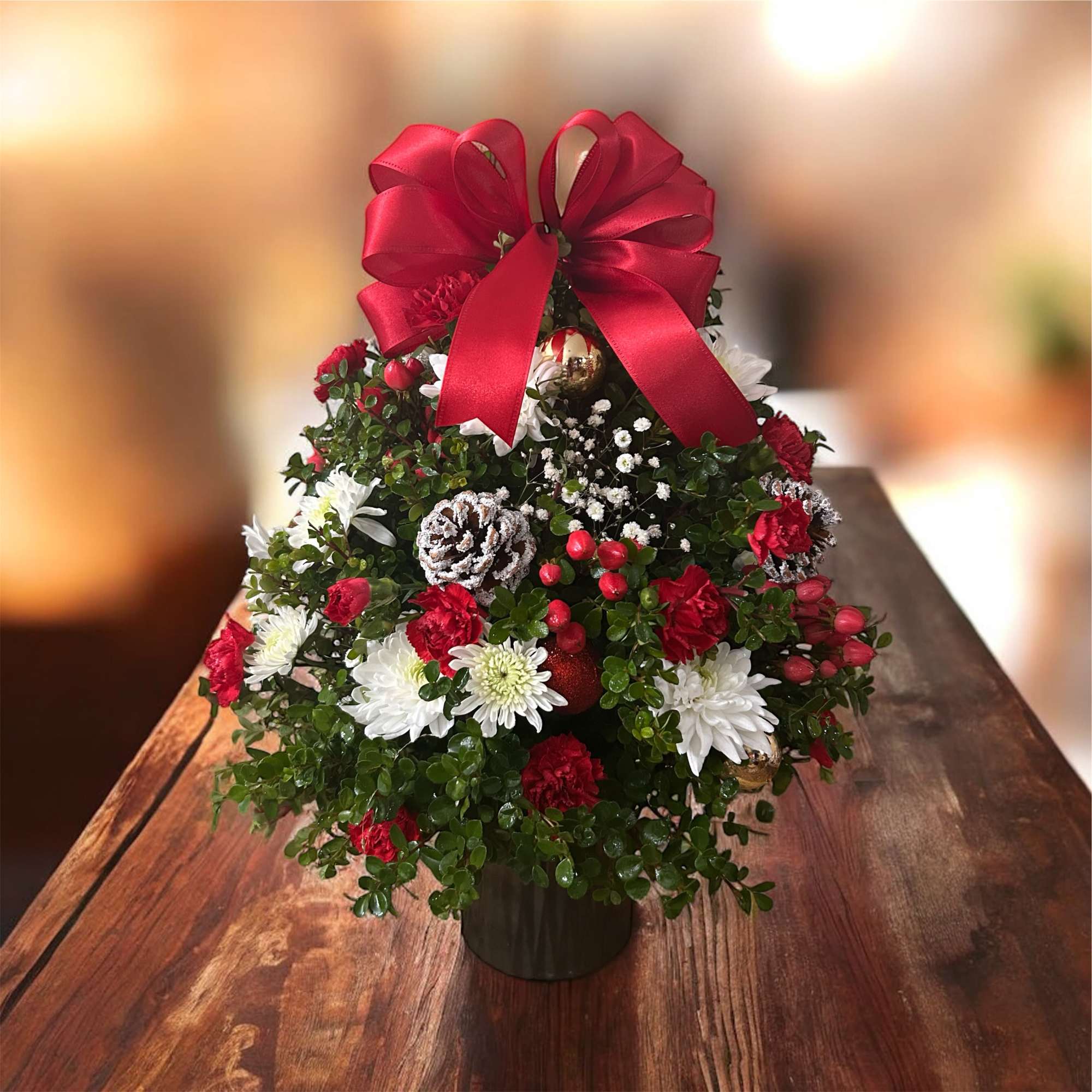 This charming fresh floral Christmas tree is beautifully handcrafted with lush greenery