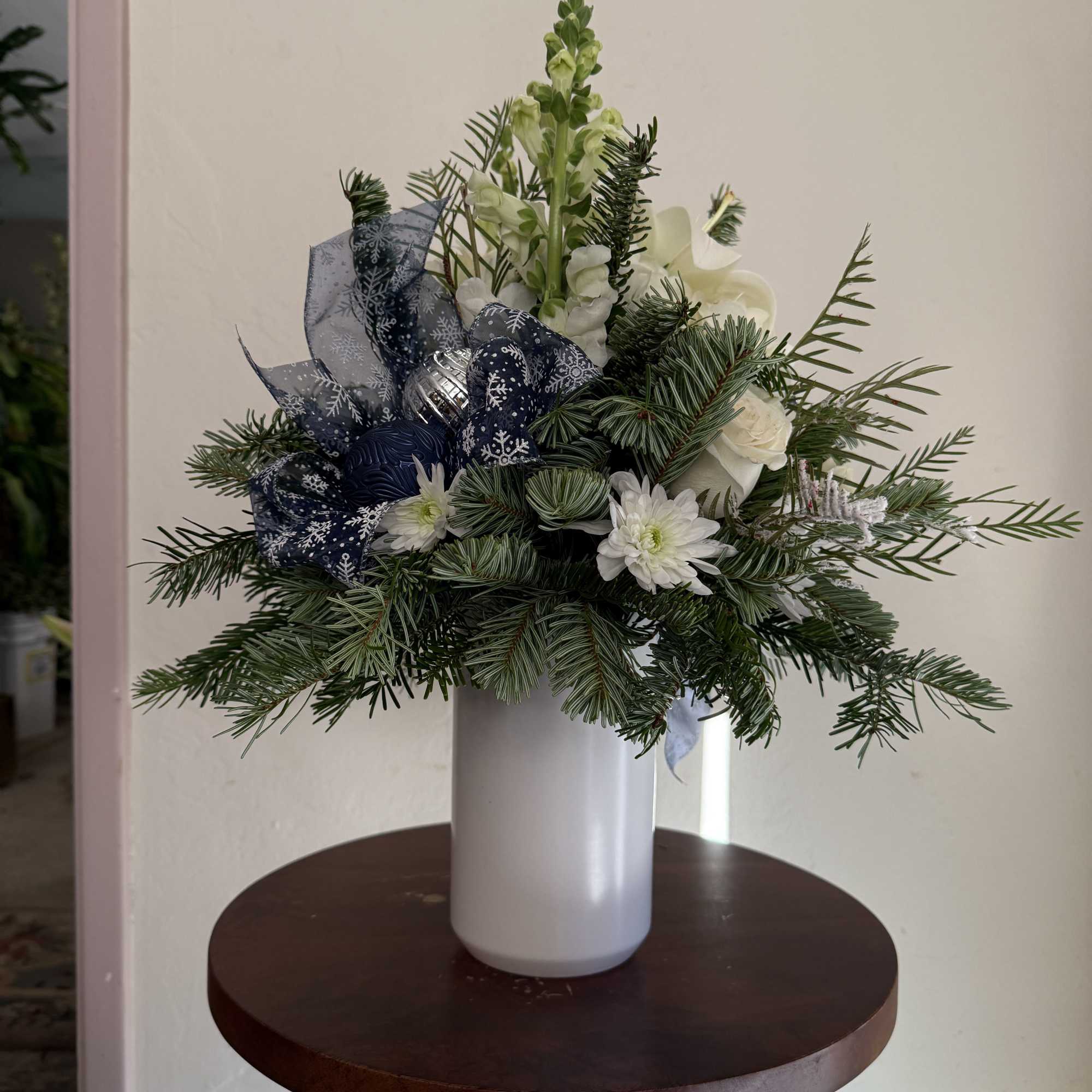 Variety of blooms, including hydranges, snapdragons, lilies, roses and cushion nestled in