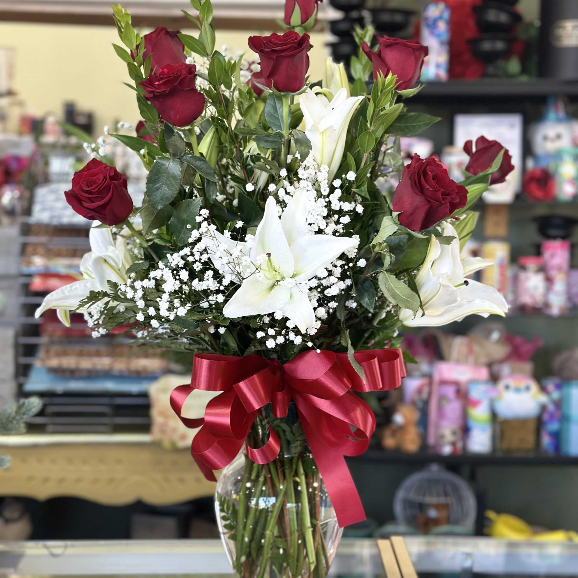 One dozen of our long stem red roses Casablanca Lilies arranged in