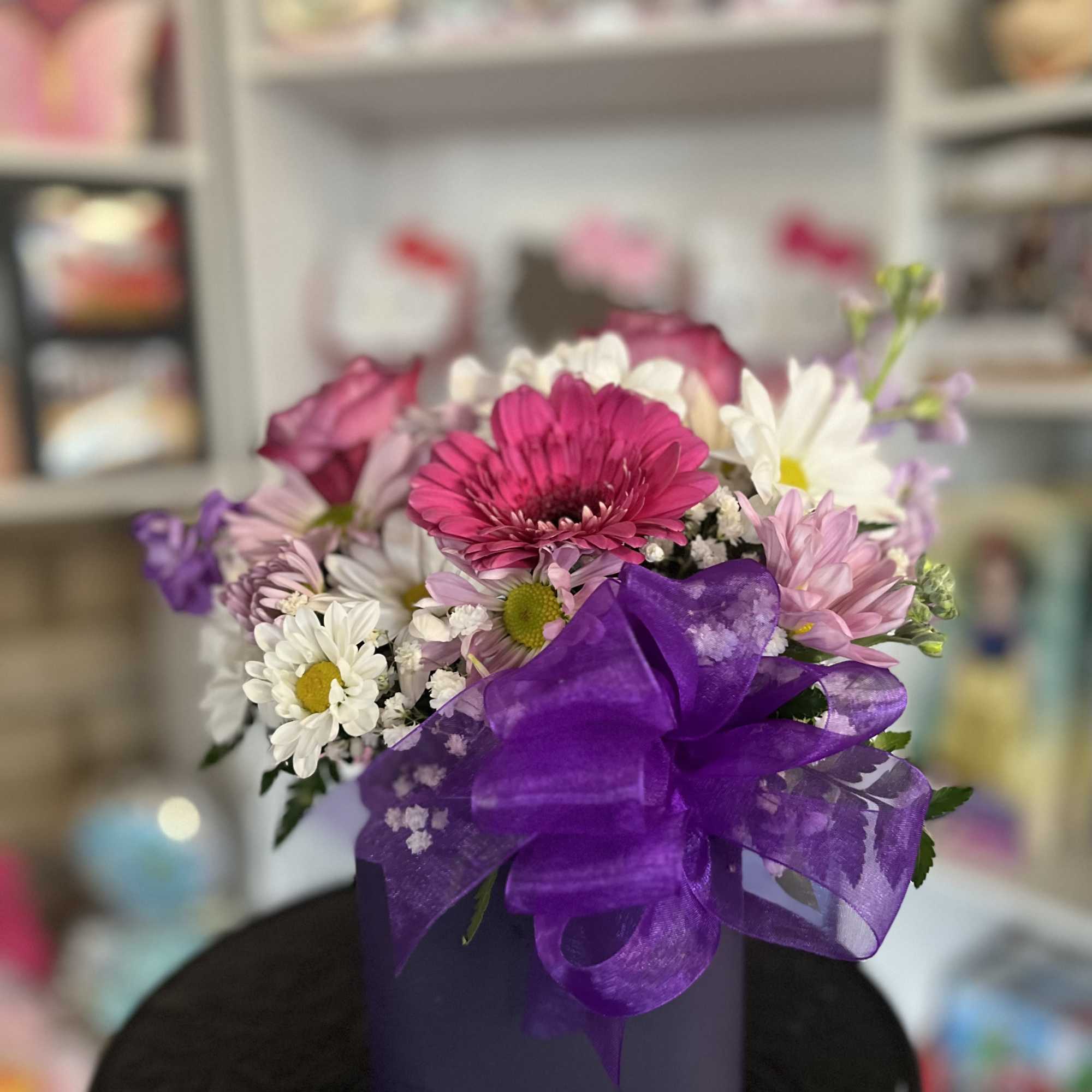 fresh flowers in purple cube vase 