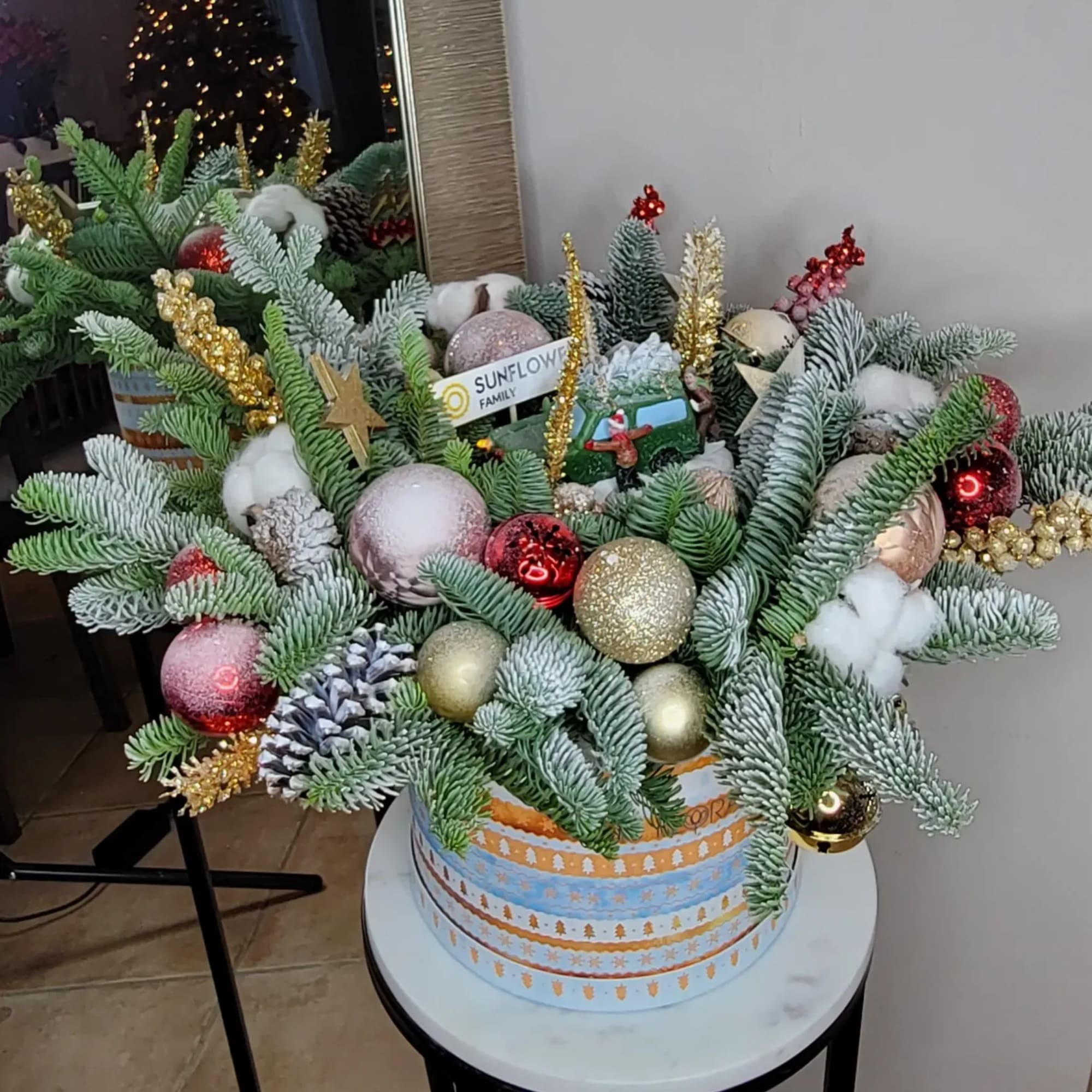 Box of fresh pine with candles, Christmas figurine and Holyday decor.