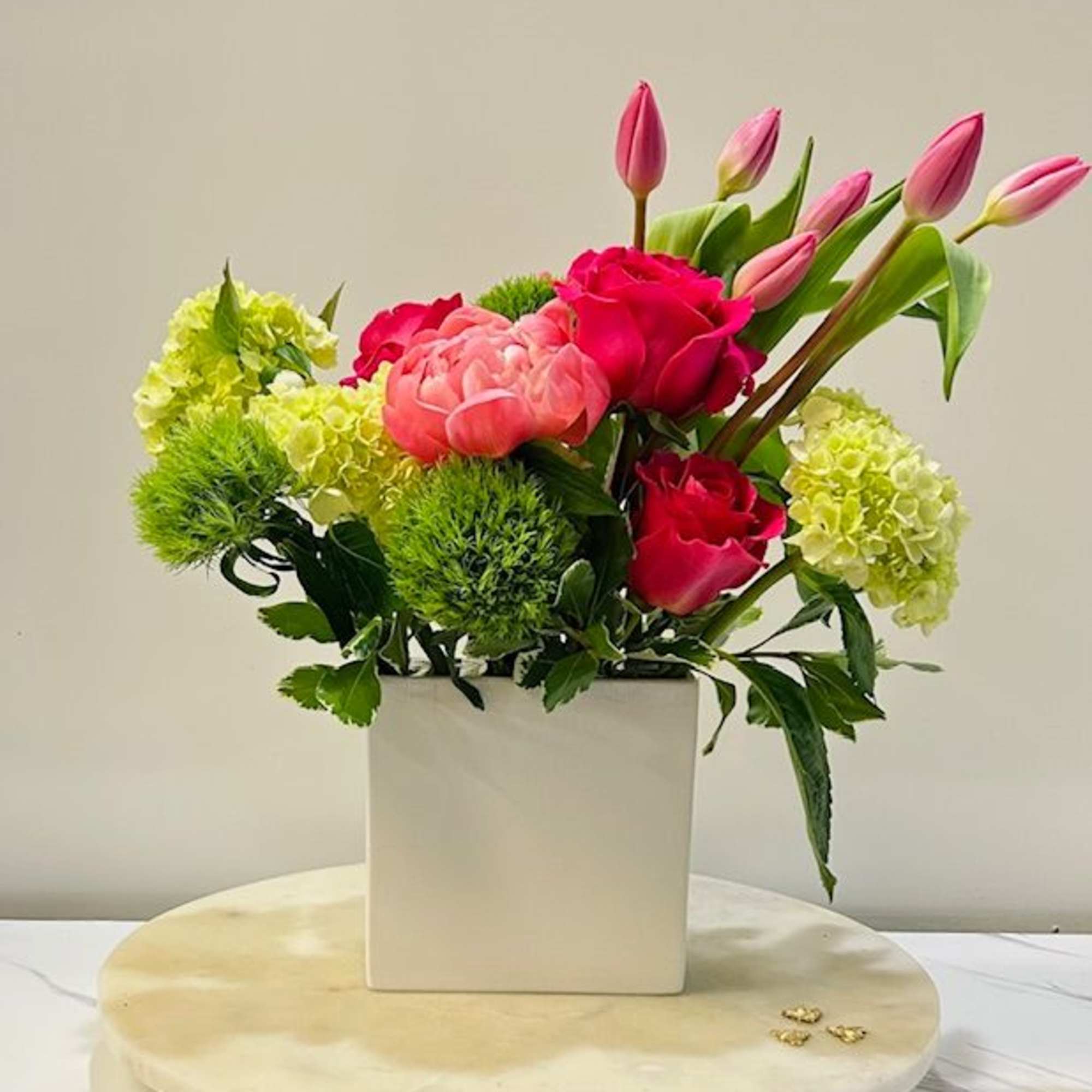 A refined blend of peonies and tulips in complementary tones, designed with