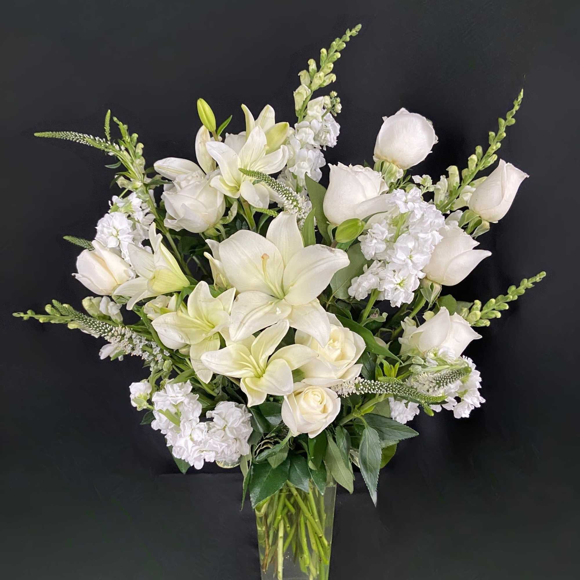 This classy arrangement is full of grace. Featuring an elegant bundle of