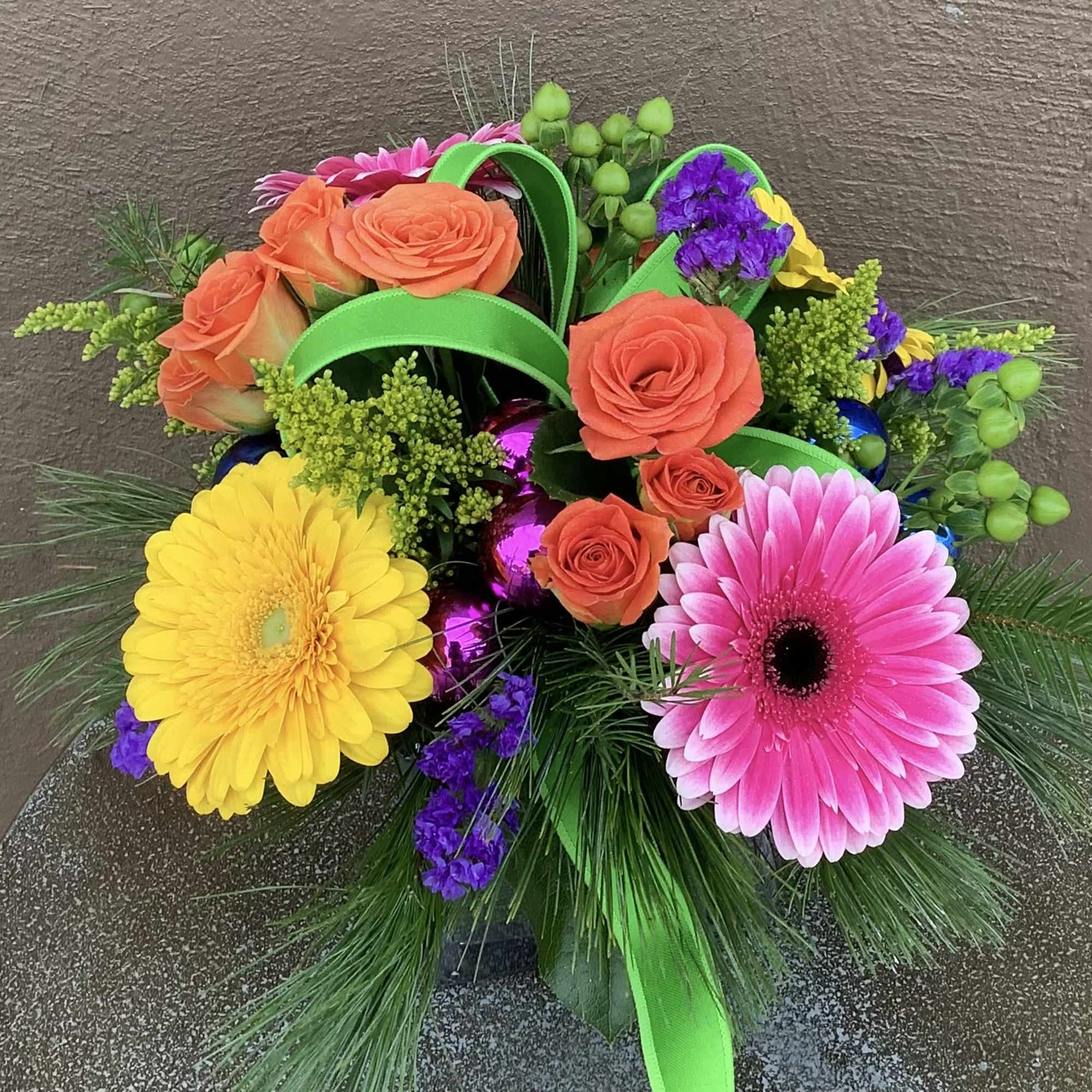 Merry and Bright colors and flowers in this cute gift like arrangement.