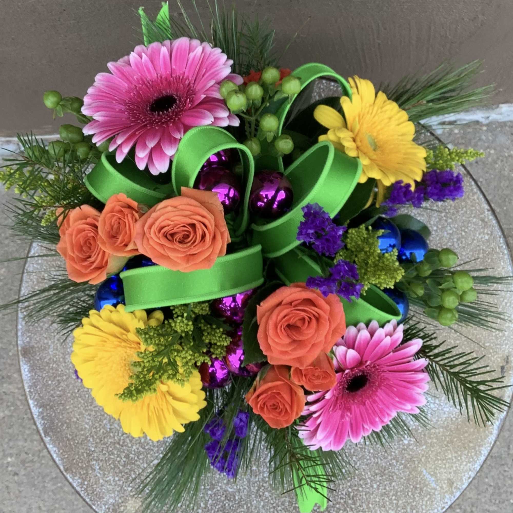 Merry and Bright colors and flowers in this cute gift like arrangement.