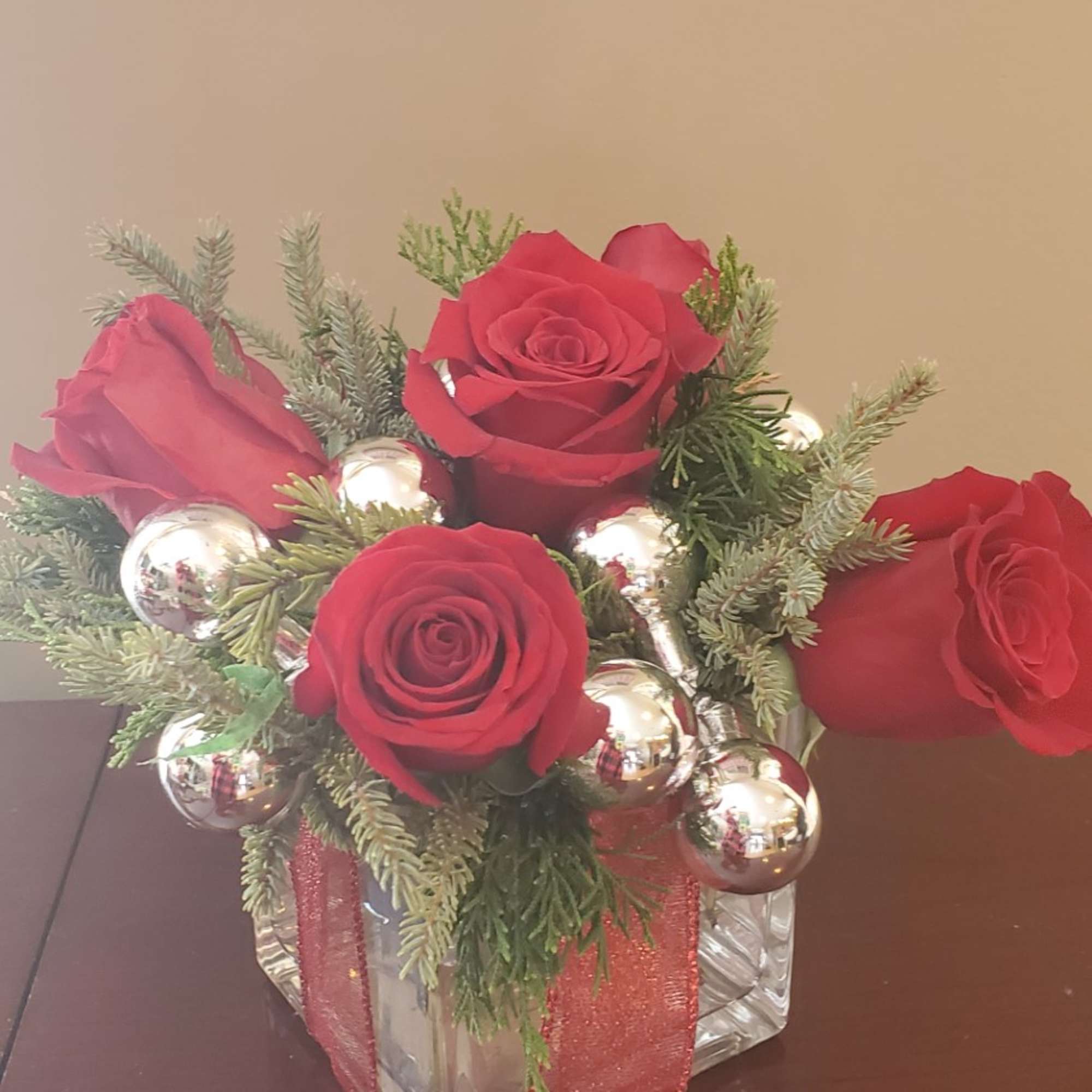 4x4 glass cube filled with winter greens, 5 red roses with some
