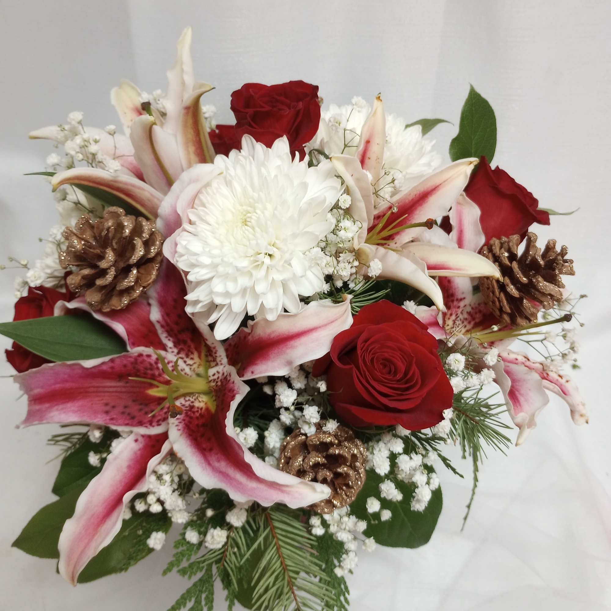 Celebrate the season with this vibrant display of red roses and hot