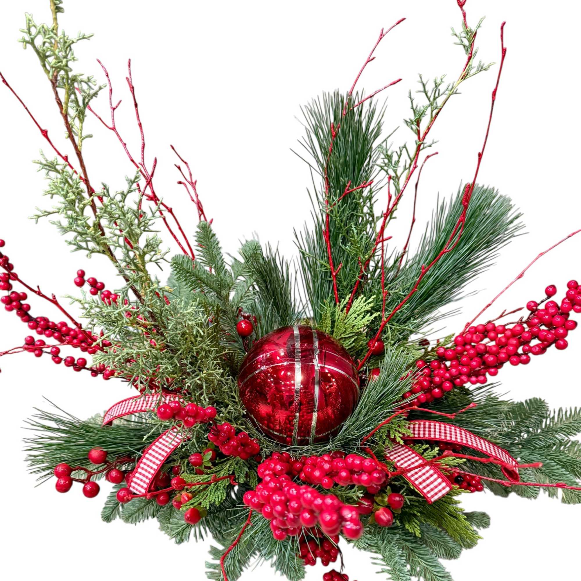 Variety of fresh winter greens, ornament keepsake, permanent berries, branches and ribbon