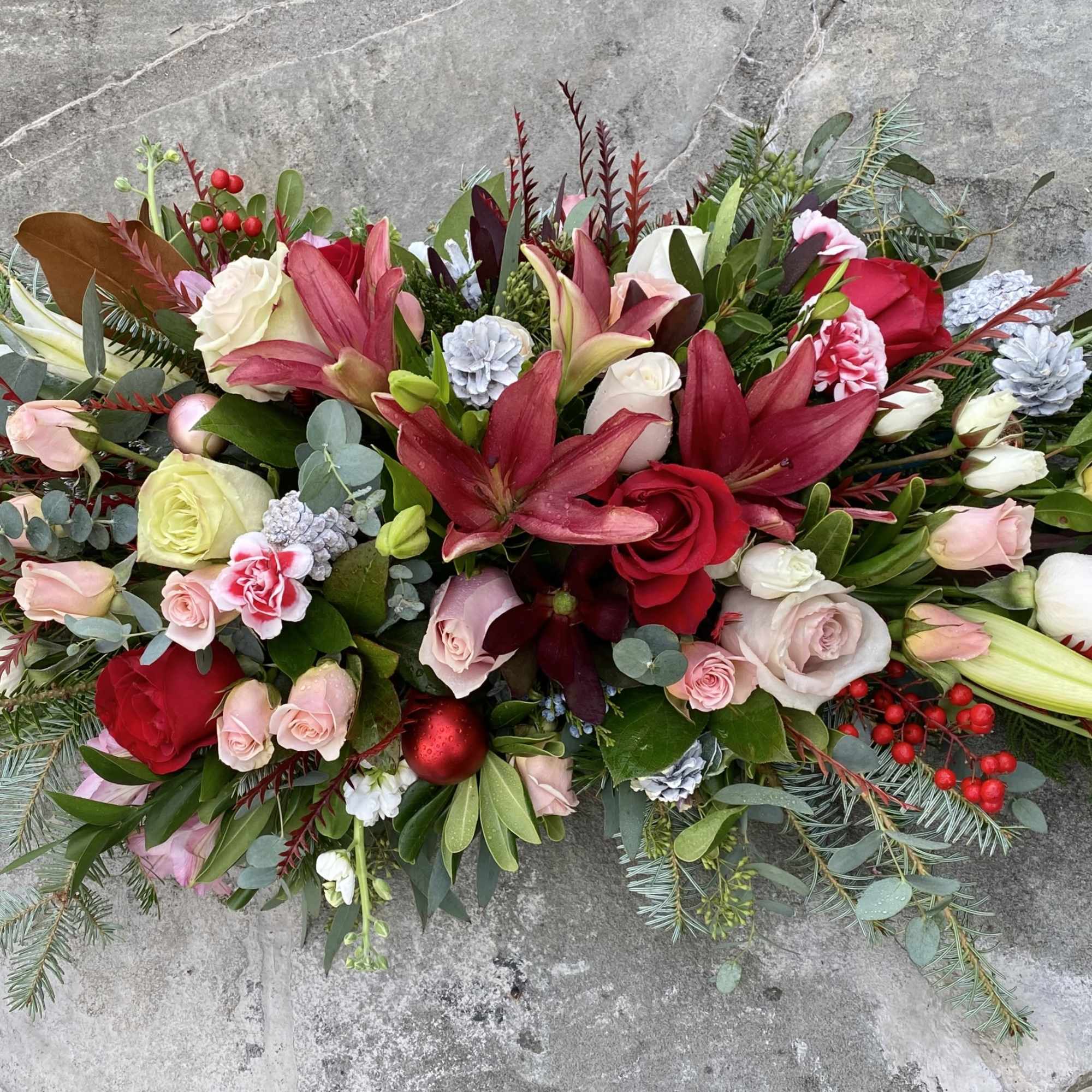 A beautiful low holiday centerpiece made various textures in warm tones, of