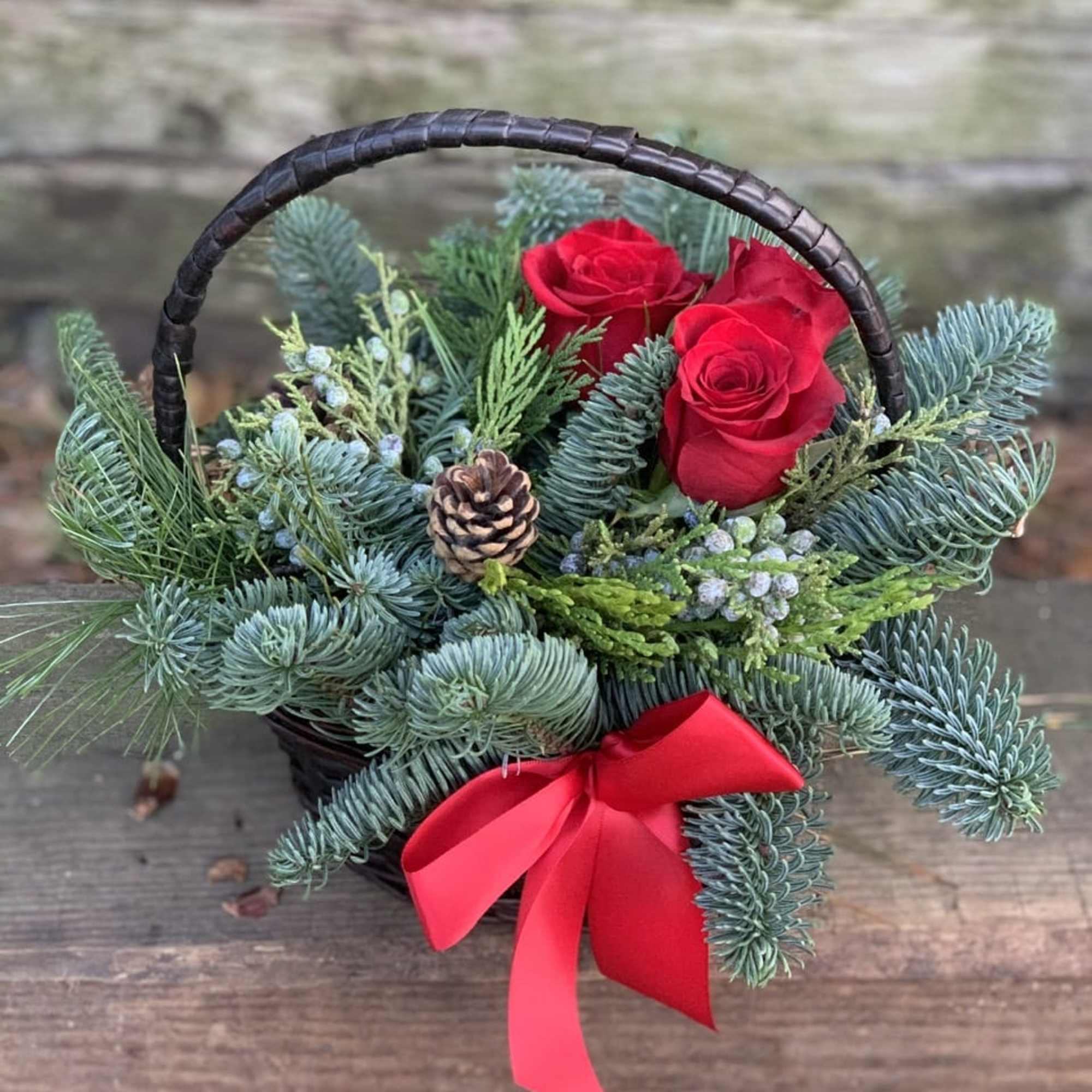 Sweet basket filled with mixed evergreens effervescent of holiday Spirits. 
Deluxe and