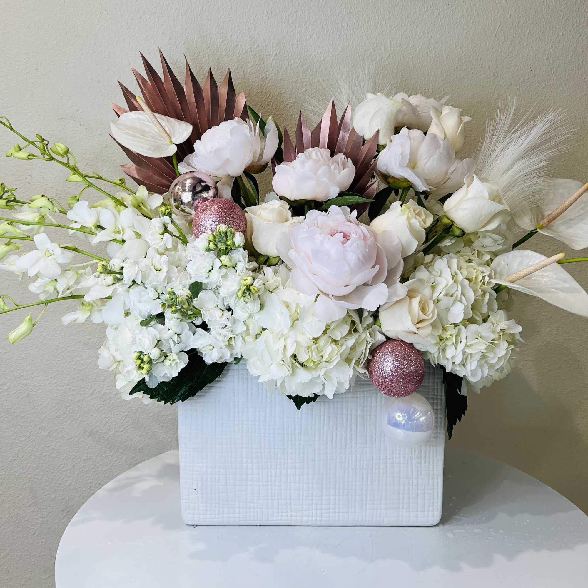 Beautiful mixture of all white and blush flowers including Peonies, Orchids, Anthurium