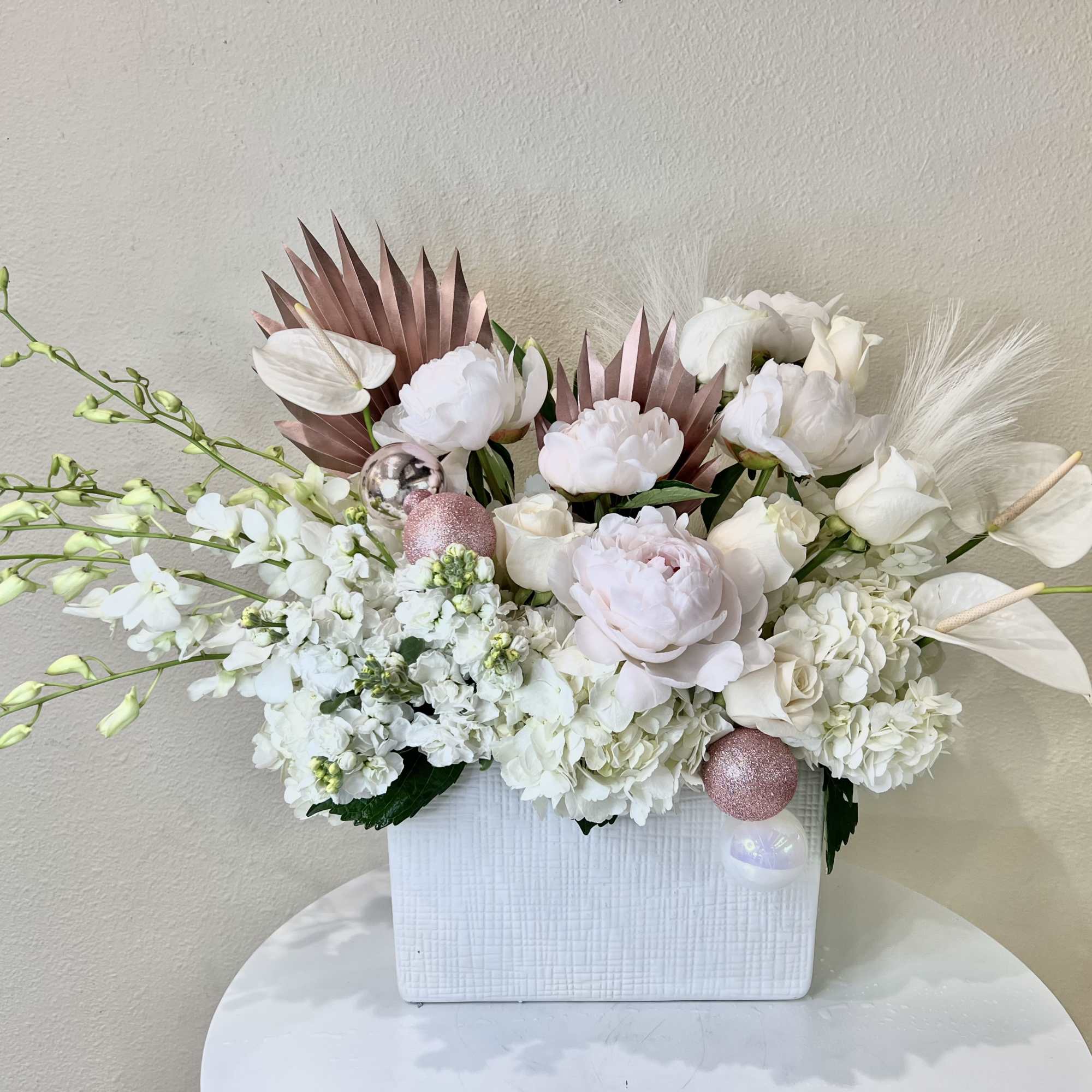 Beautiful mixture of all white and blush flowers including Peonies, Orchids, Anthurium