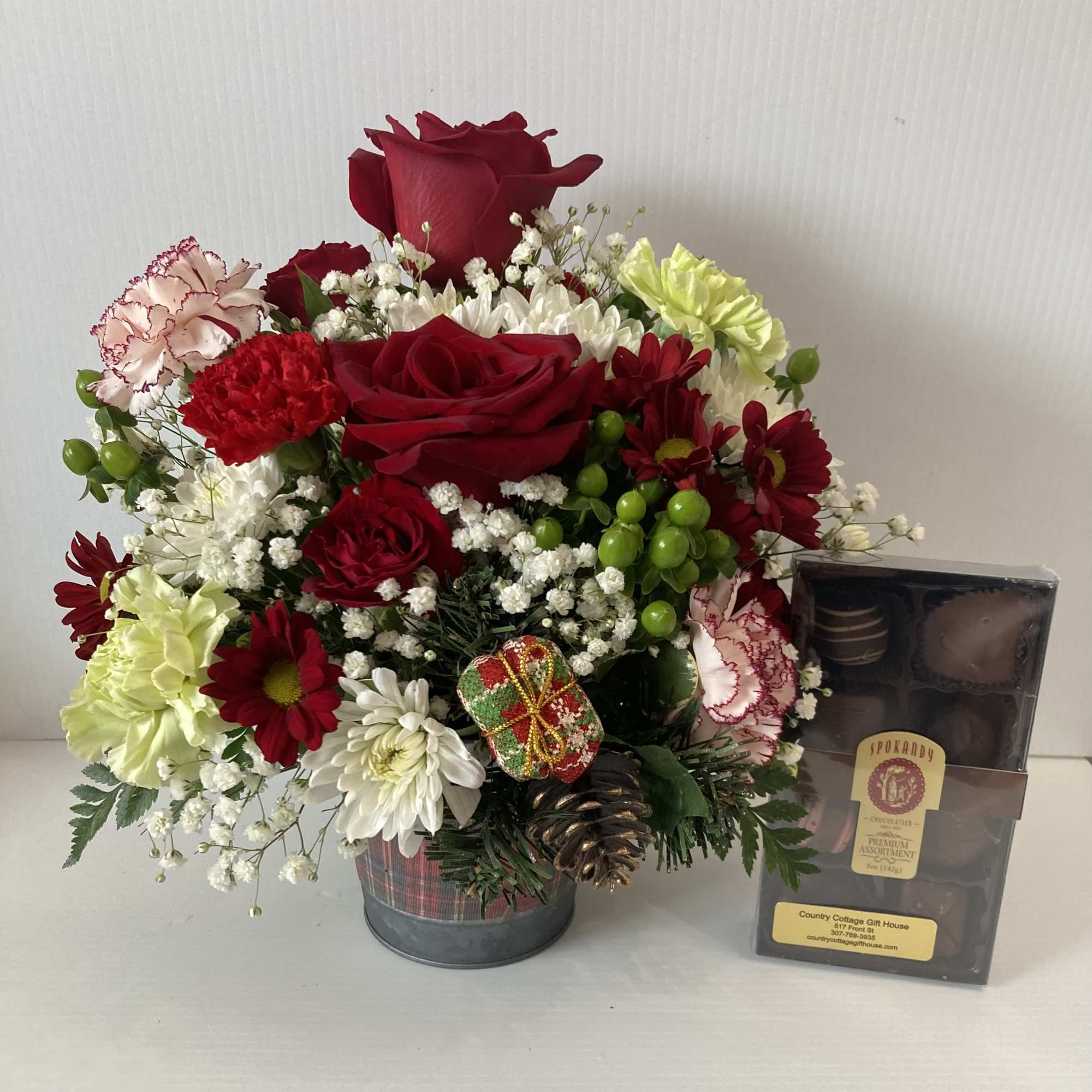 Holiday arrangement in a cute plaid metal pot with Christmas tree on