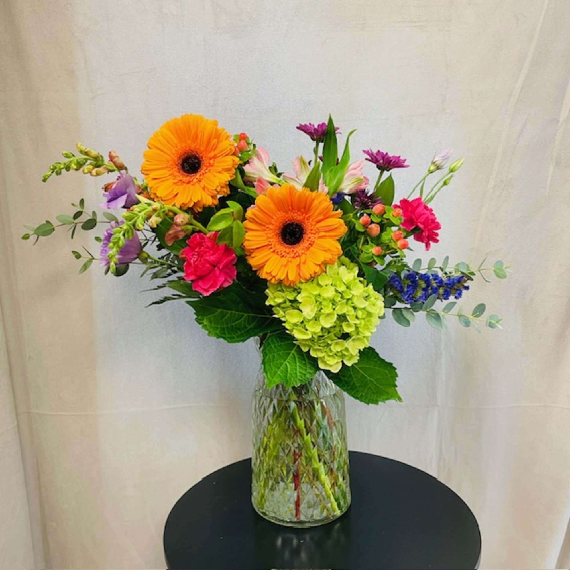 A selection of bright and cheerful flowers arranged in a vase or