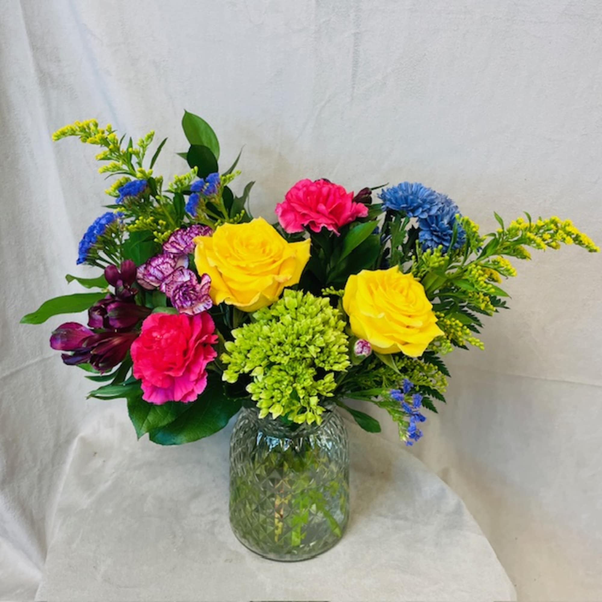 A selection of bright and cheerful flowers arranged in a vase or